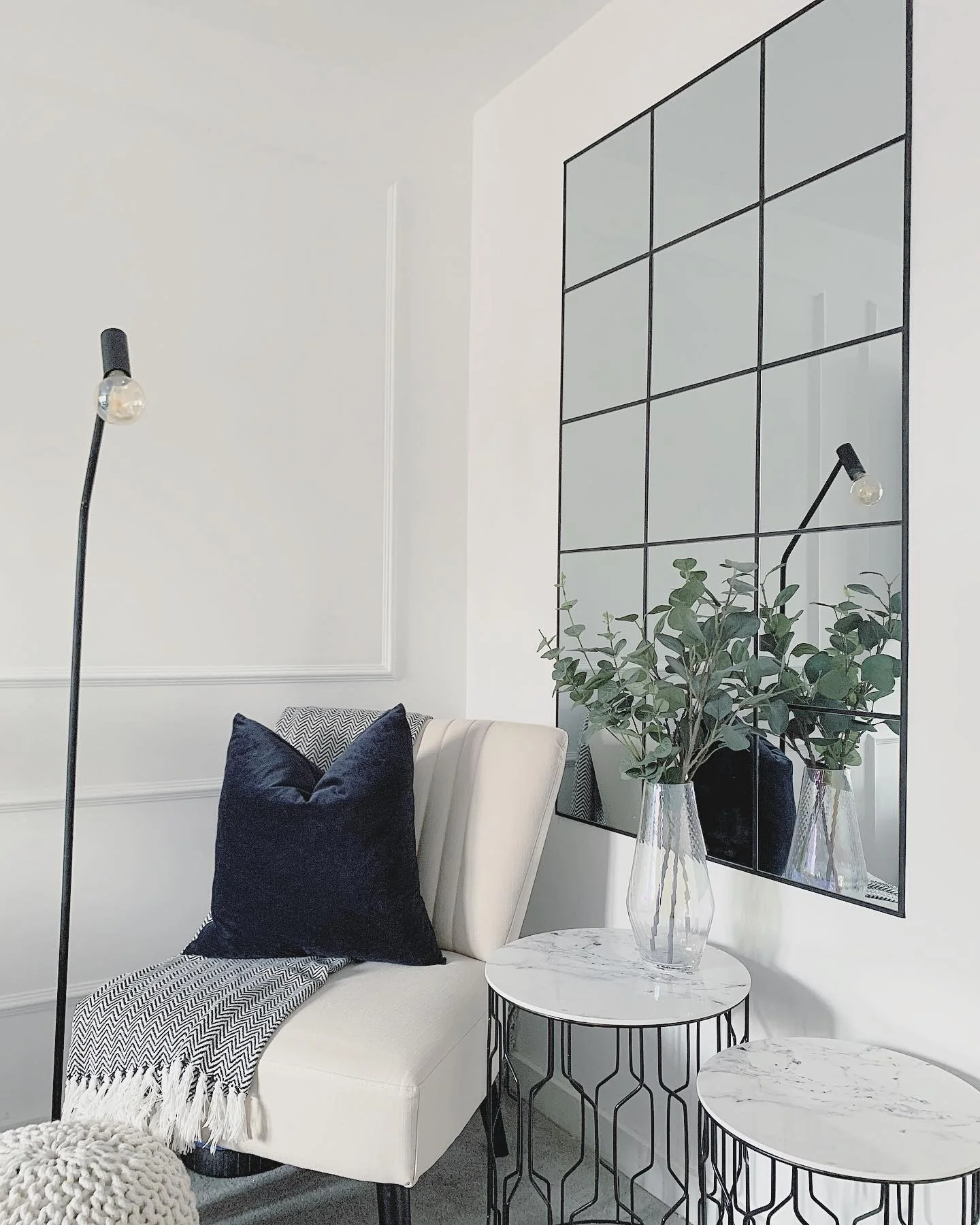 14. Black-Framed Grid Mirror in a Monochrome Nook (Living Room Mirror Ideas)