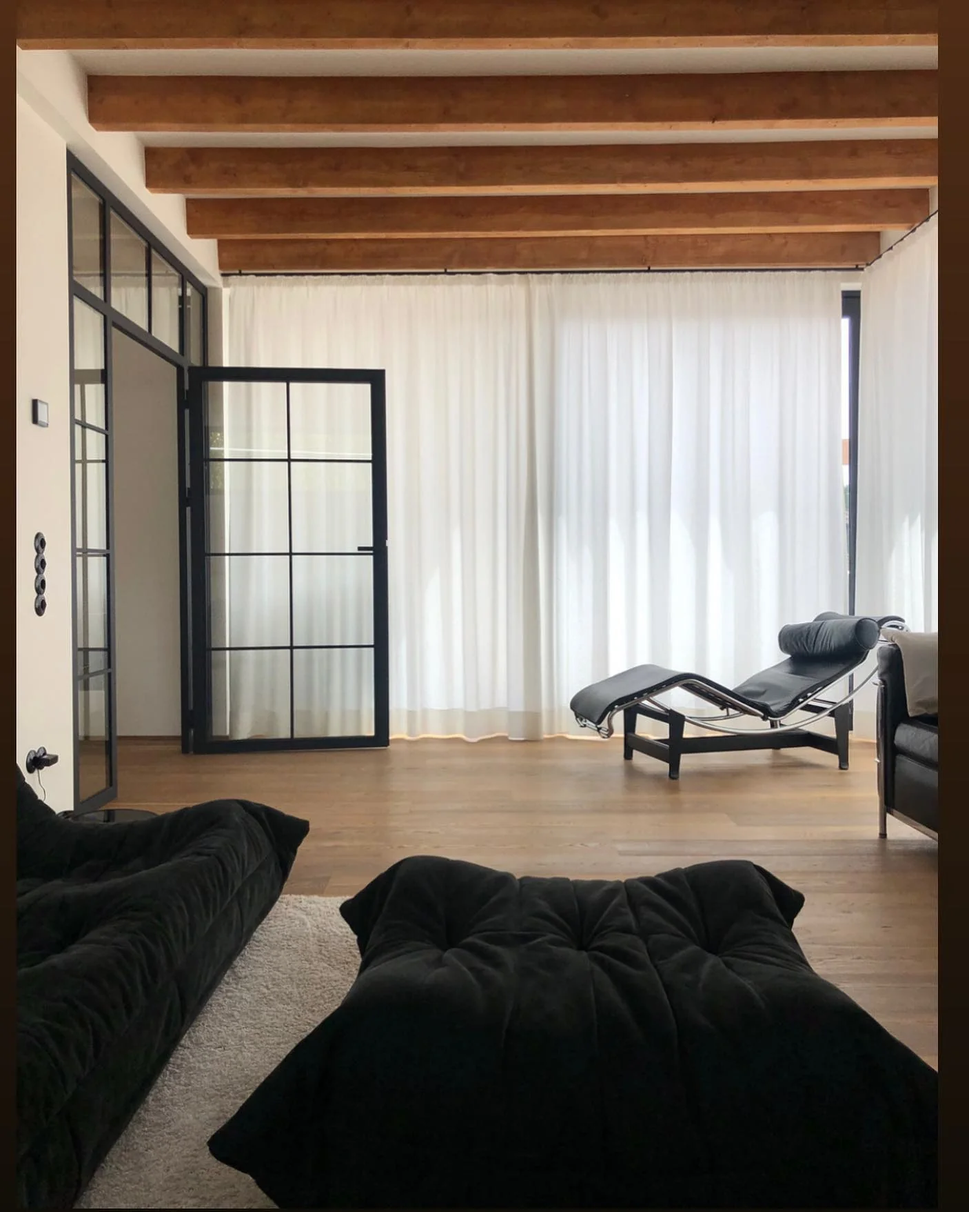 5. Open and Minimalist Industrial Loft (Black Furniture Living Room Ideas)