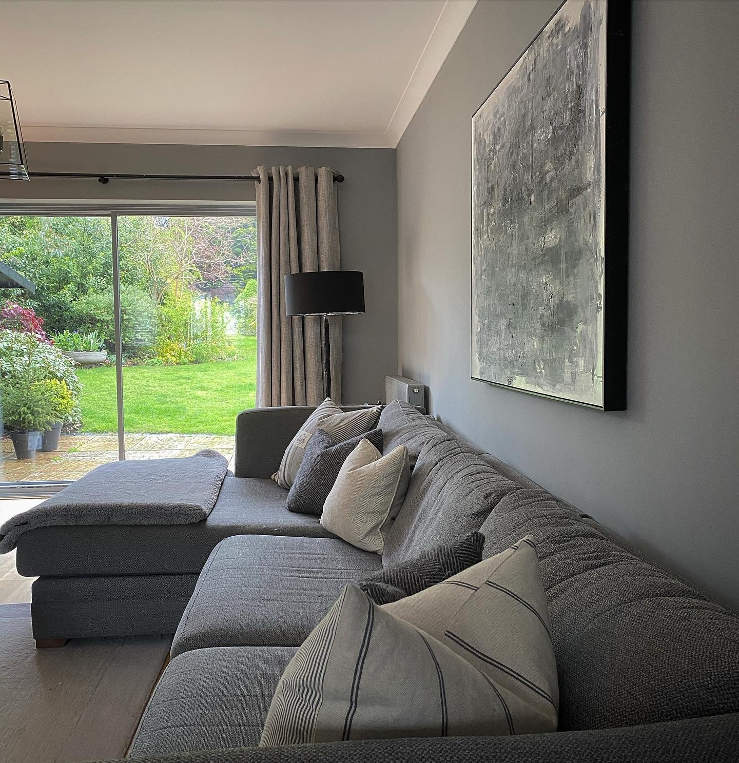 2. Layered Neutrals with Garden Views (Dark Grey Living Room Ideas)