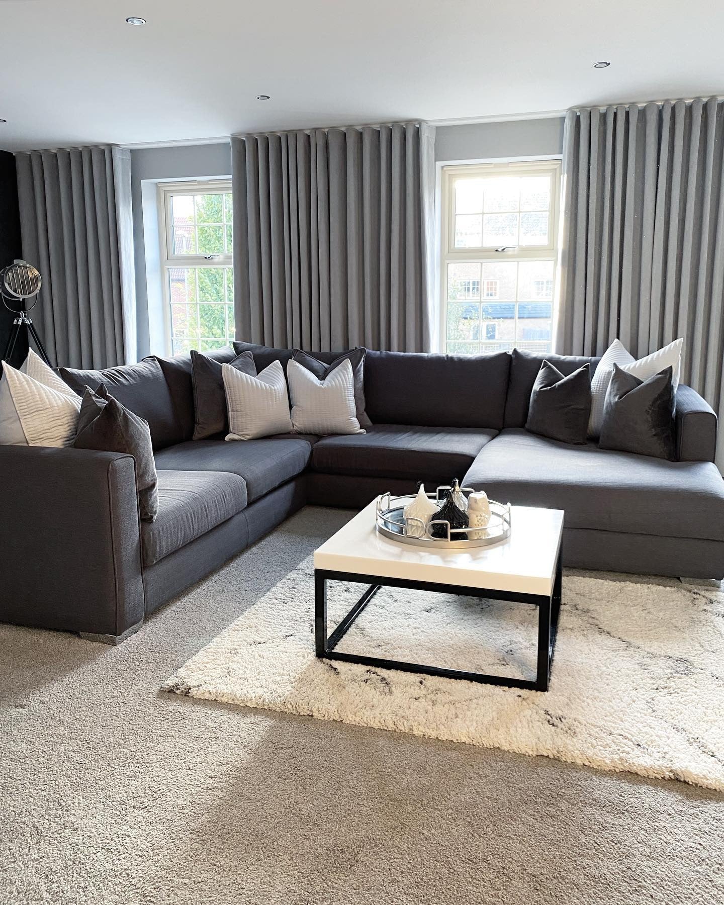 9. Tailored Warmth with Monochrome Drapes (Dark Grey Living Room Ideas)