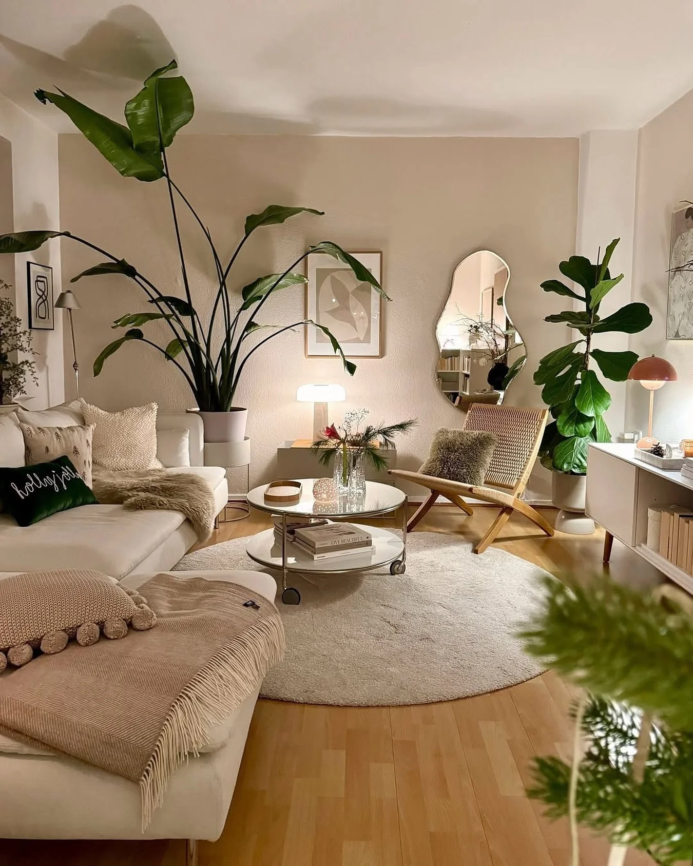 15. Evening Glow with Indoor Greenery (Beige Couch Living Room Ideas)