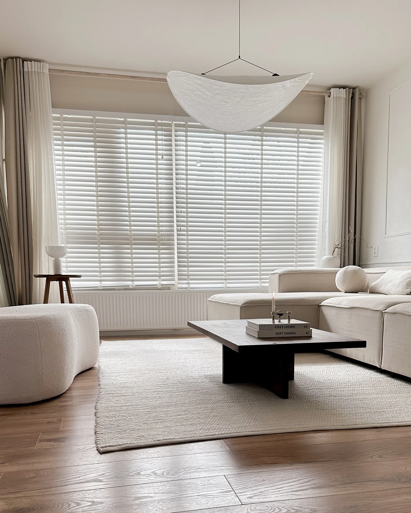 12. Minimalist Contrast with Sculptural Lighting (Beige Couch Living Room Ideas)