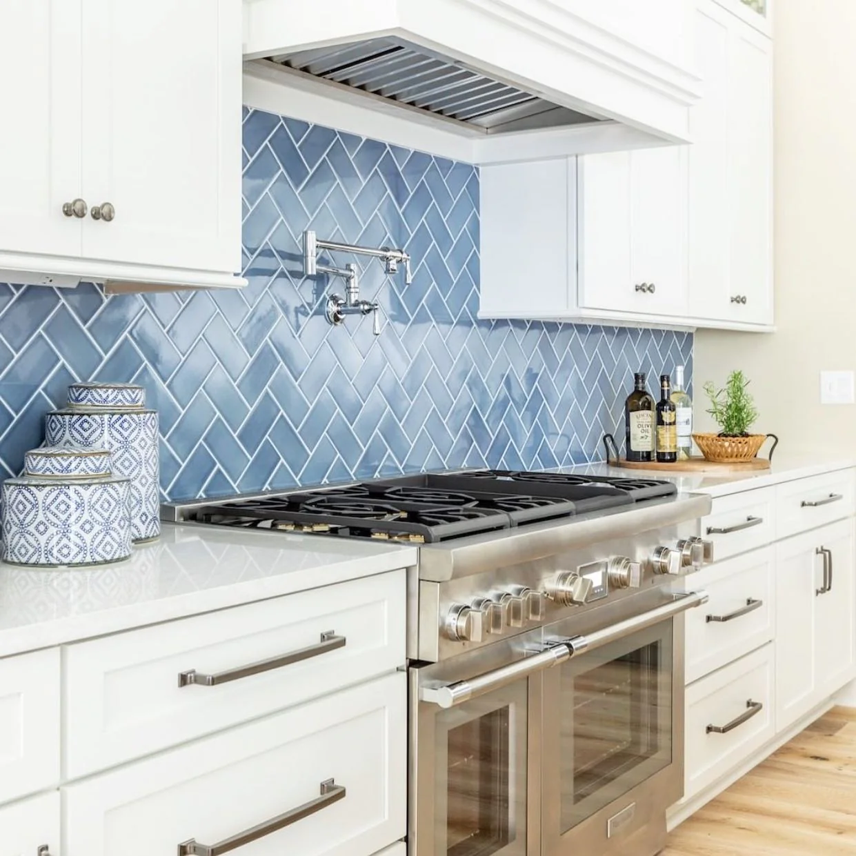 13. Glossy Denim Herringbone with White Shaker Cabinets (Blue Backsplash Kitchen Ideas)