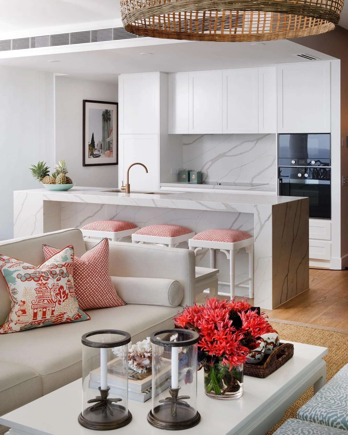 2. Coastal Elegance with White Marble and Coral Accents (Living Room and Kitchen Ideas)