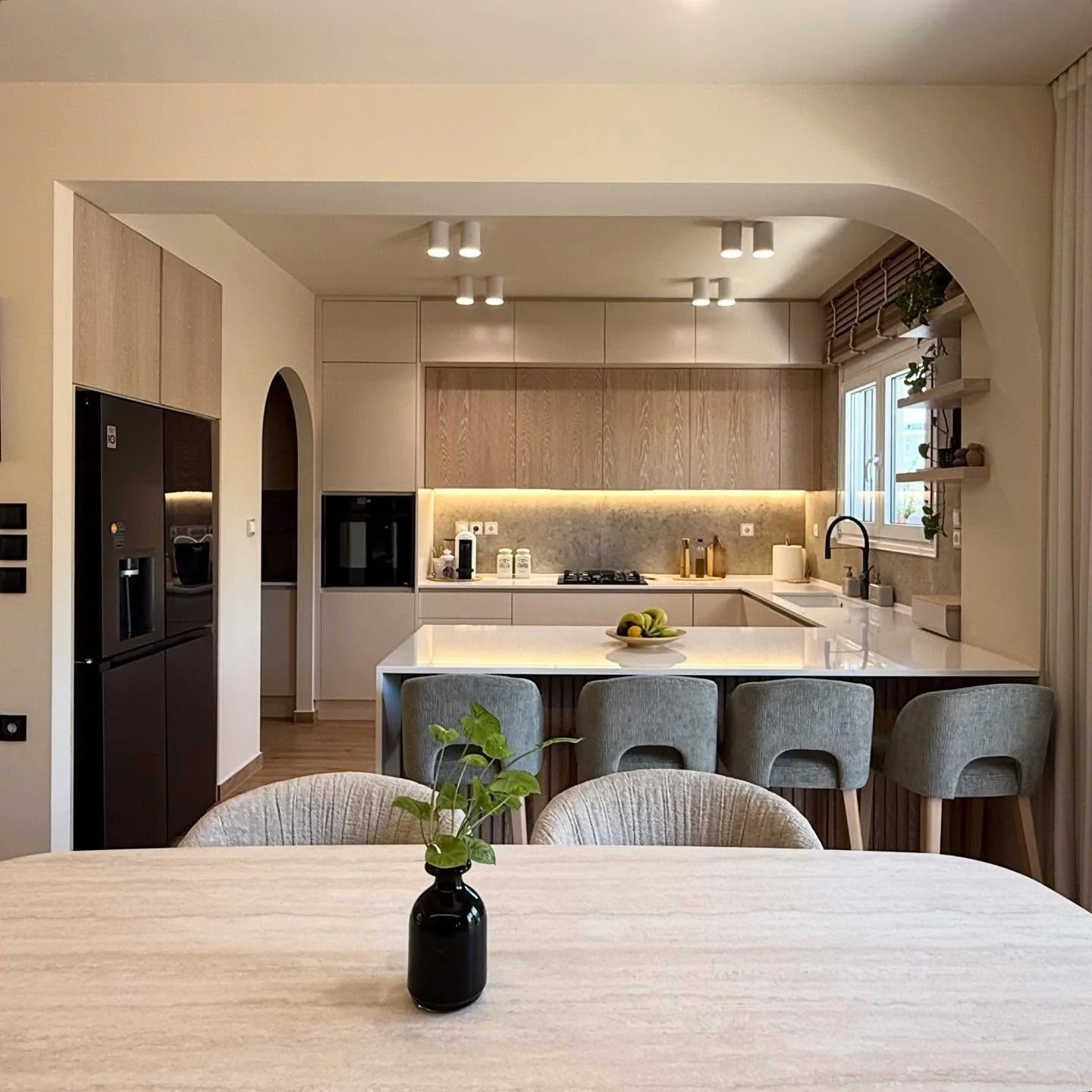 13. Arched Minimalism with Soft Wood and Taupe Tones (Living Room and Kitchen Ideas)