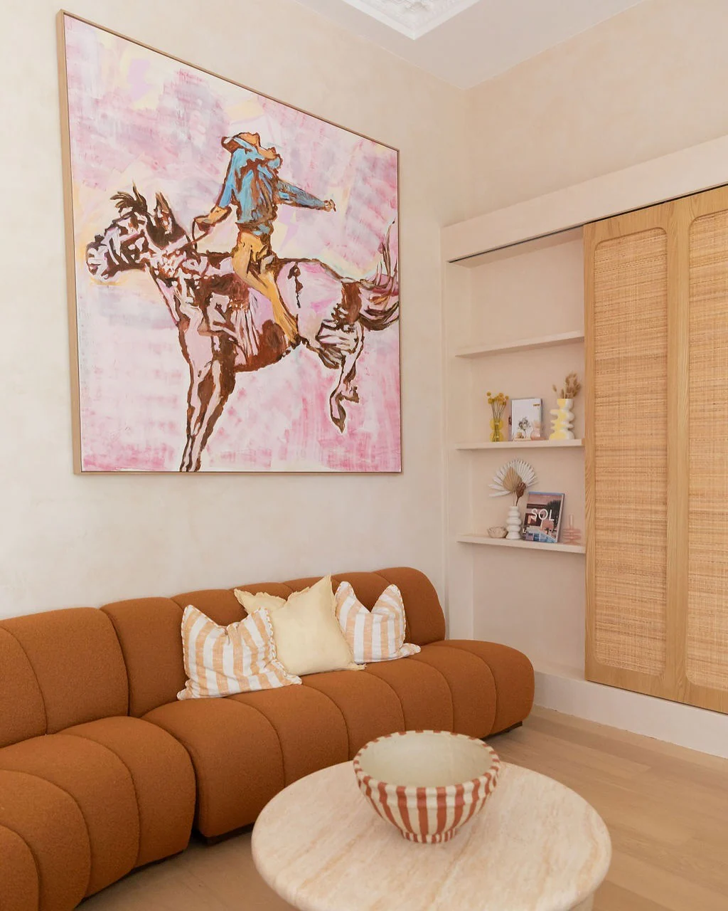 13. Soft Desert Pink Meets Western Pop Art (Accent Wall Ideas for Living Room)