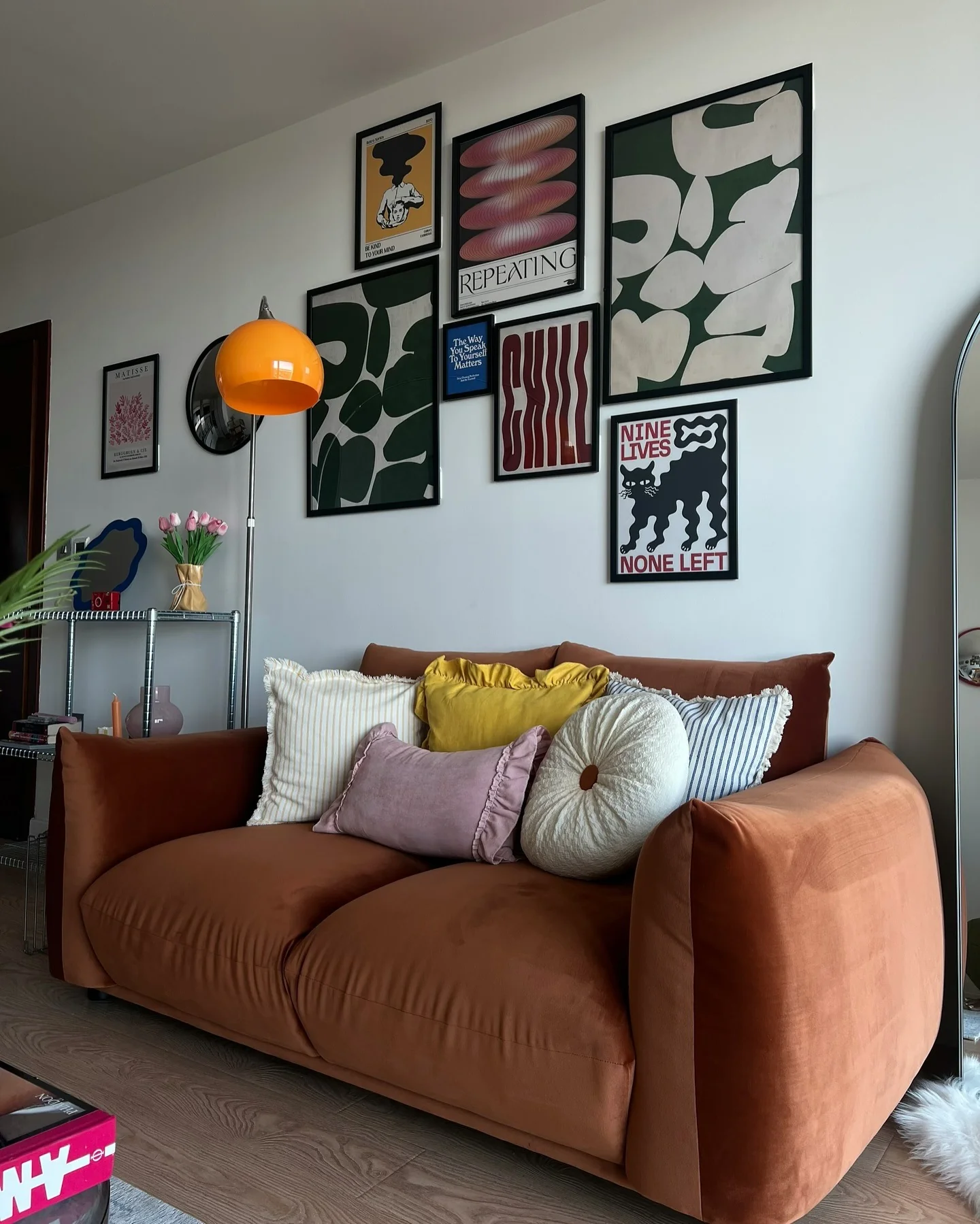 3. Mid-Mod Punch with Retro Orange Flair (Gallery Wall Living Room Ideas)