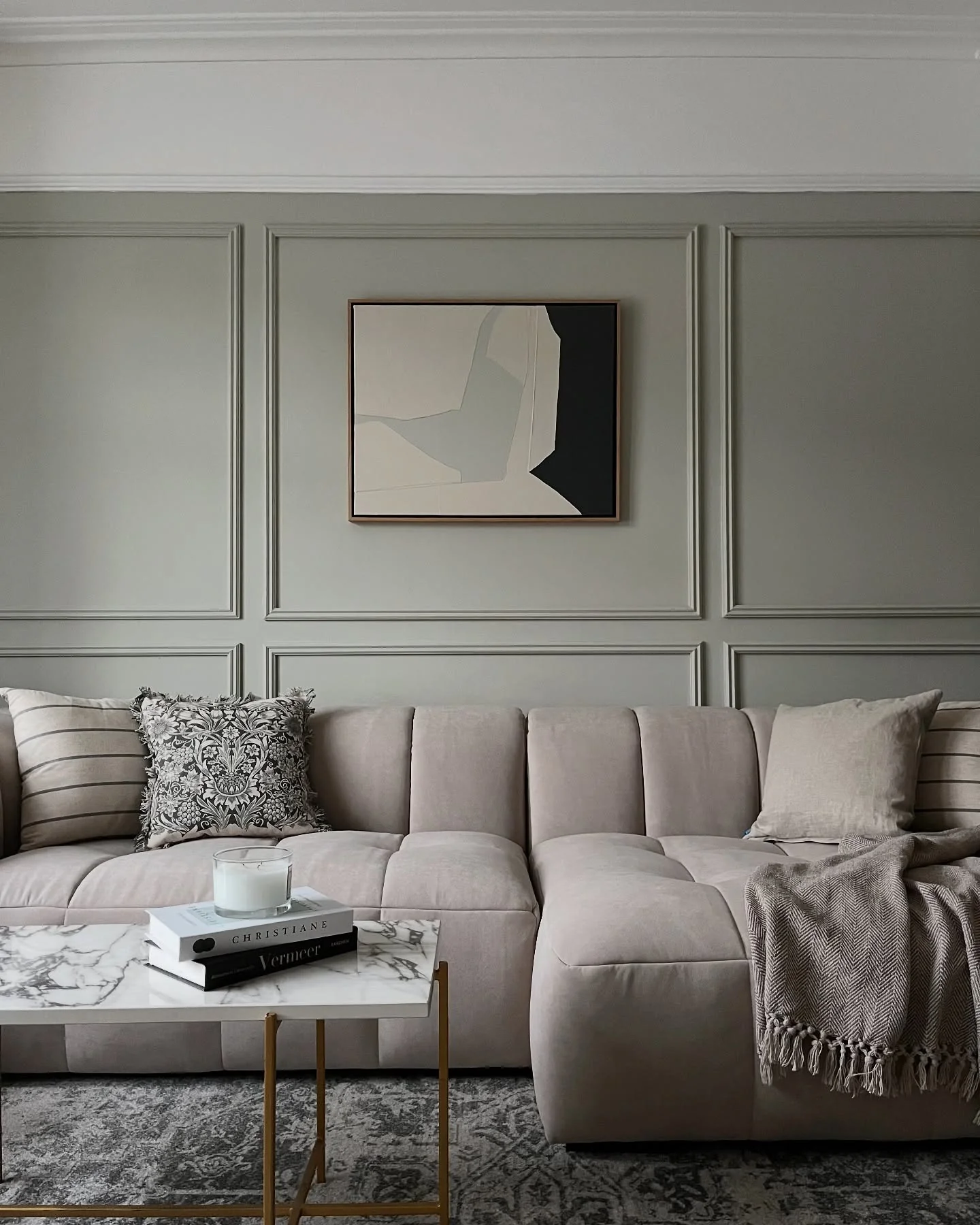 7. Tailored Neutrals with Structured Paneling (Sage Green Living Room Ideas)