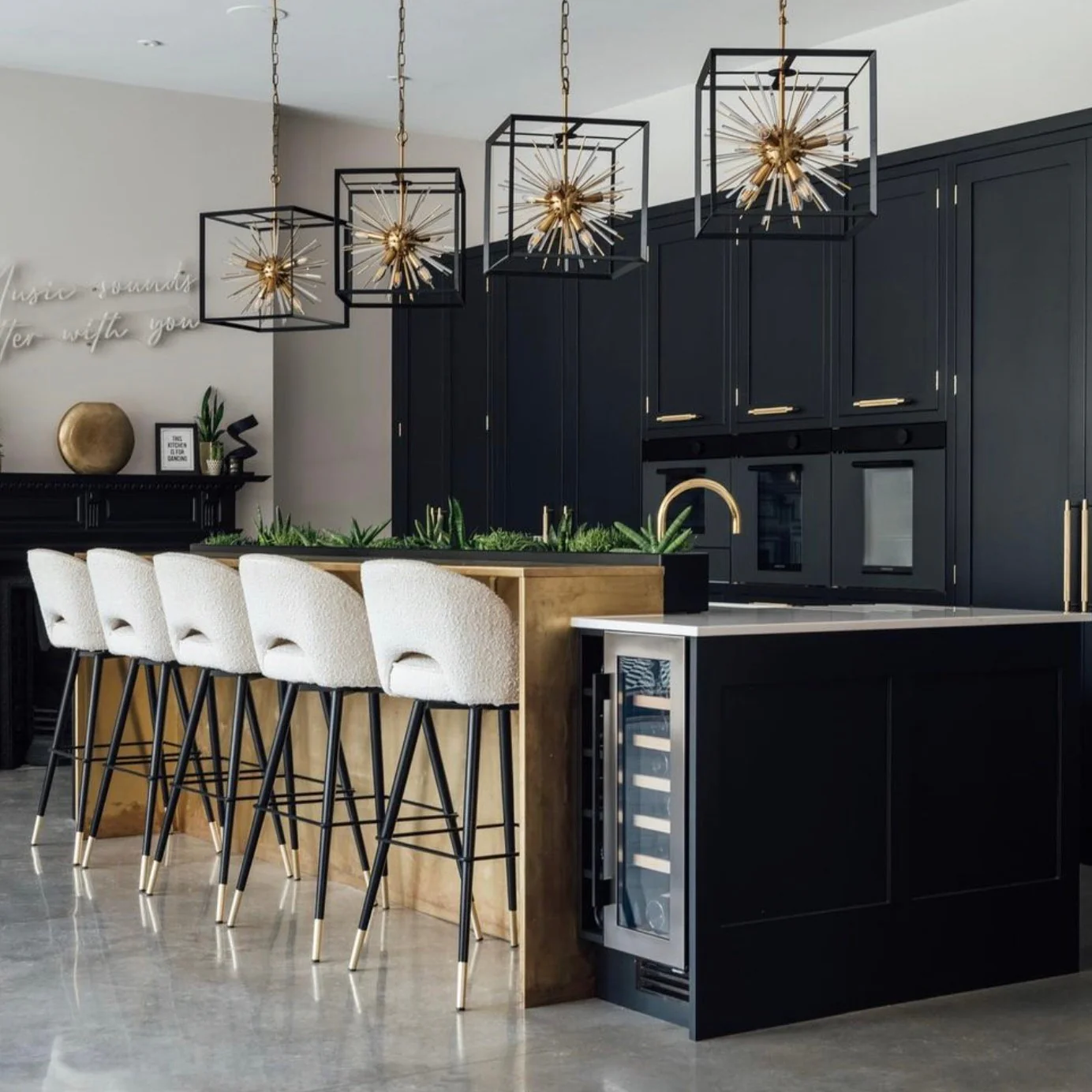 10. Contemporary Glamour with Geometric Lighting (Black Kitchen Ideas)