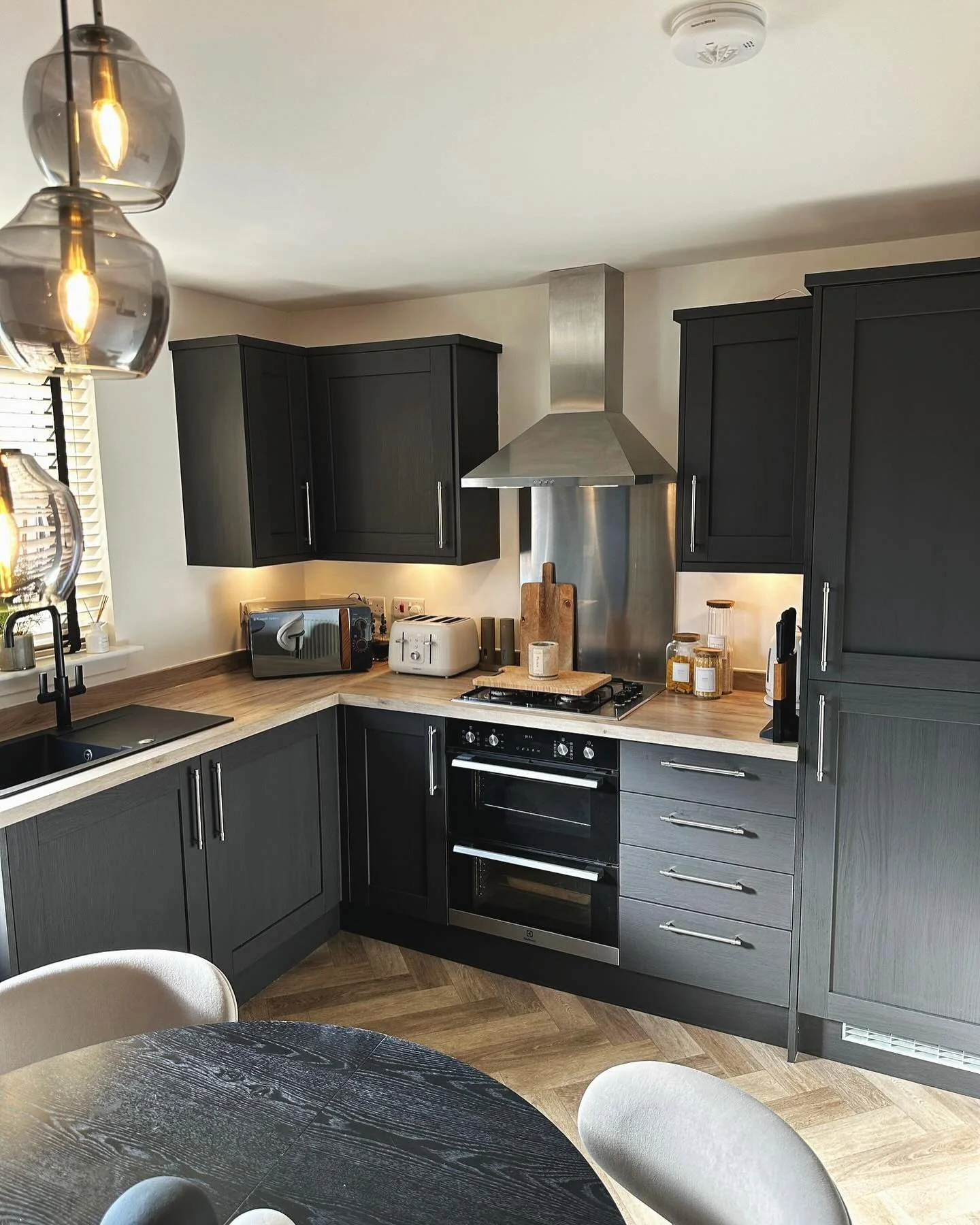 14. Compact Functionality in Warm Black (Black Kitchen Ideas)