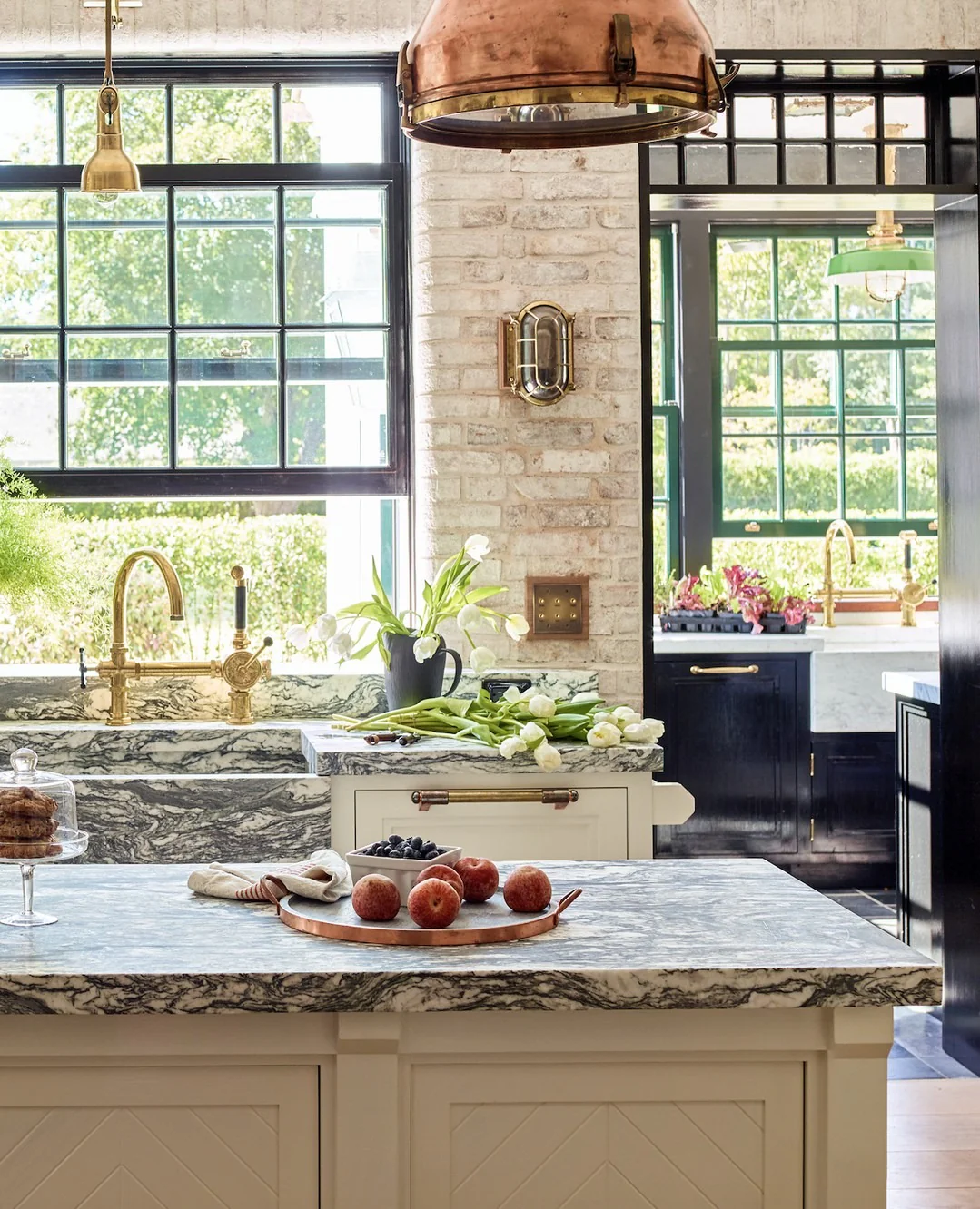 2. Modern Classic with Brass Details and Picture Window (Kitchen Window Ideas)