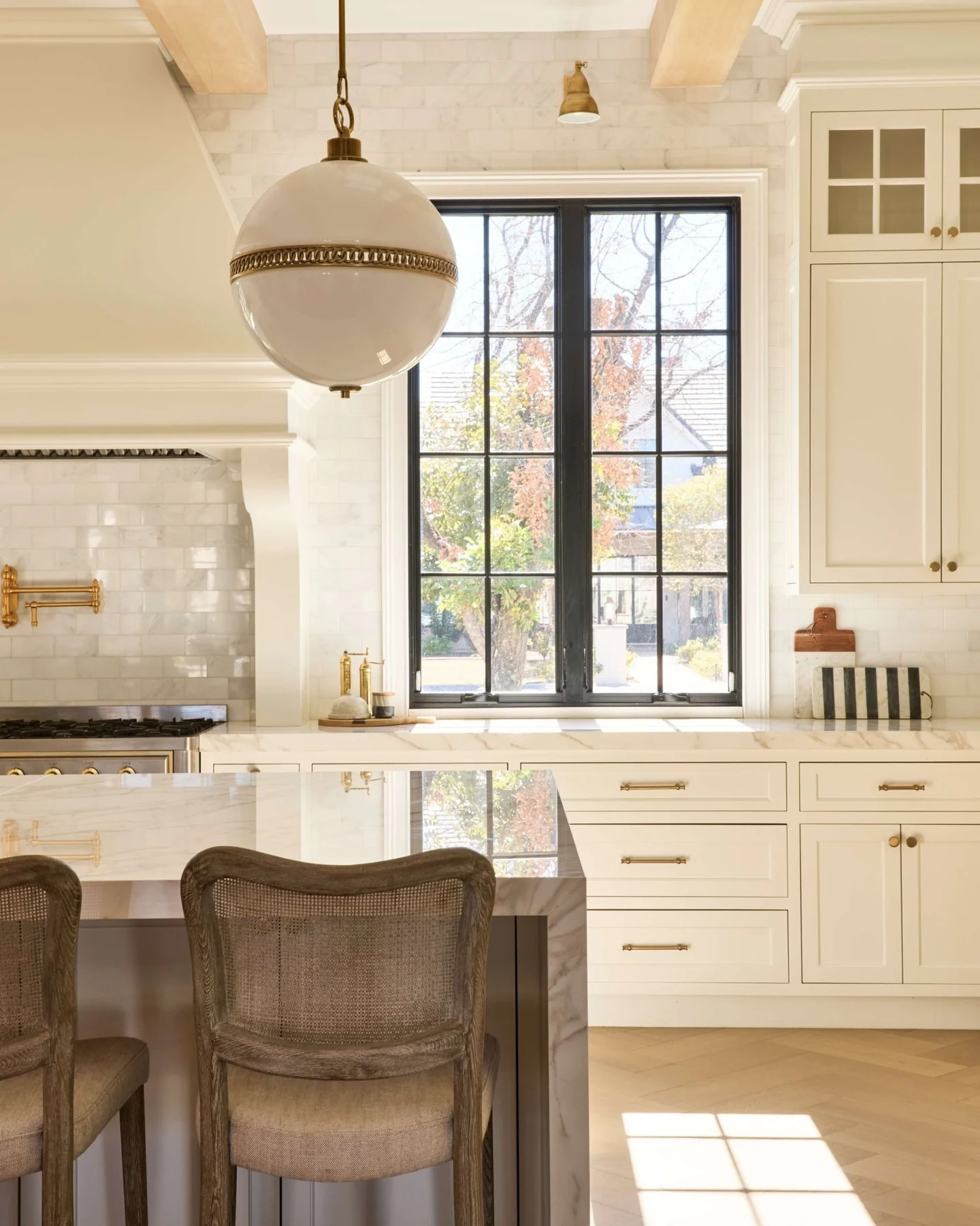 7. Soft Gold Elegance Framing a Classic Black-Trim Window (Kitchen Window Ideas)