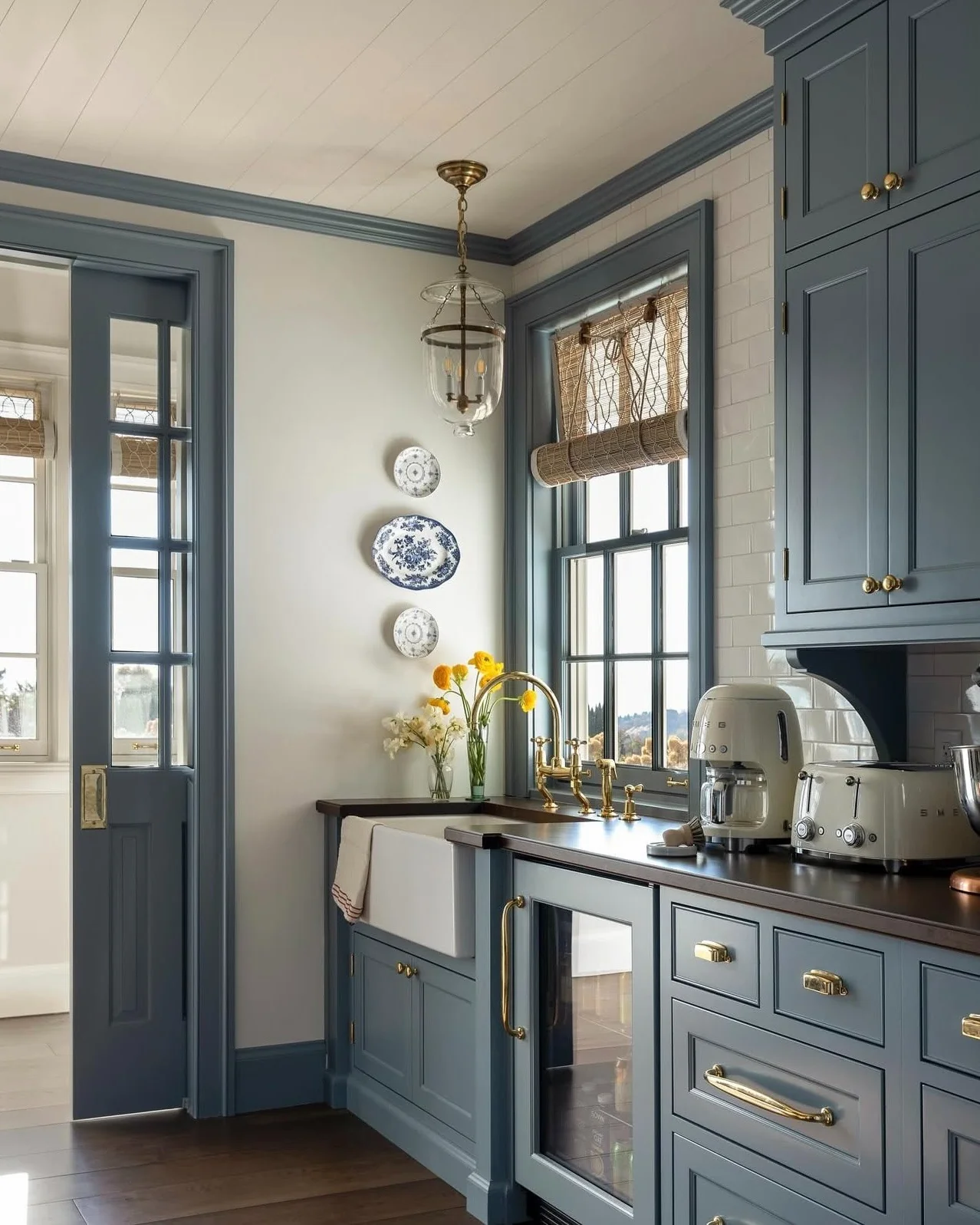 15. Blue Heritage Cabinetry Framing Tall Mullioned Windows (Kitchen Window Ideas)