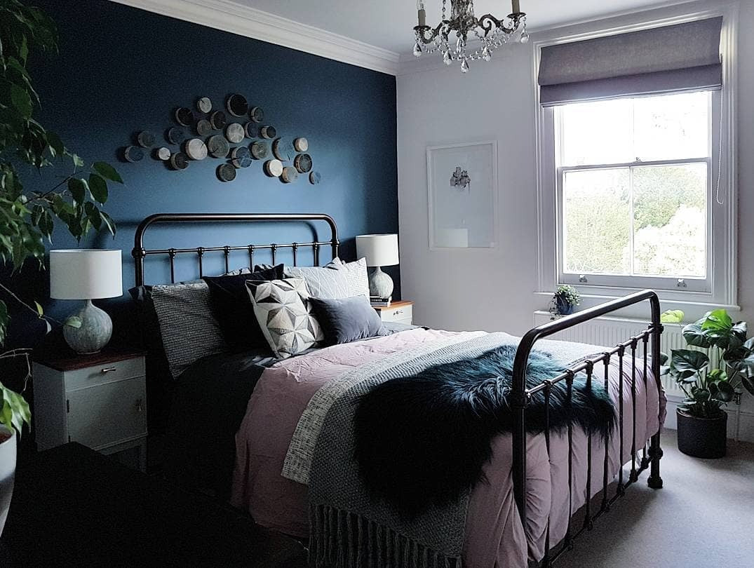 10. Eclectic Elegance with Vintage Iron (Dark Blue Bedroom Ideas)