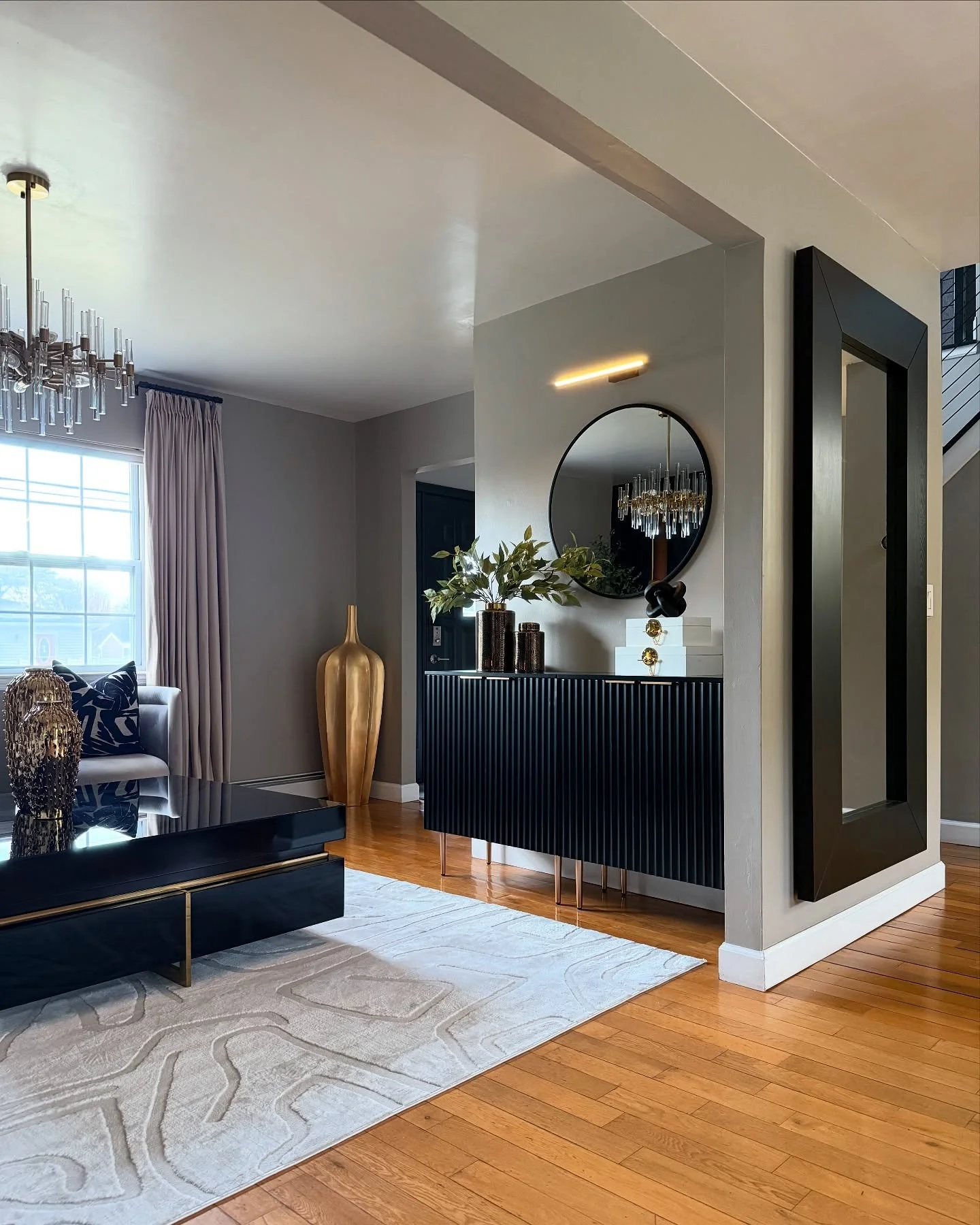 13. Entry Elegance with Structured Simplicity (Black and Gold Living Room Ideas)