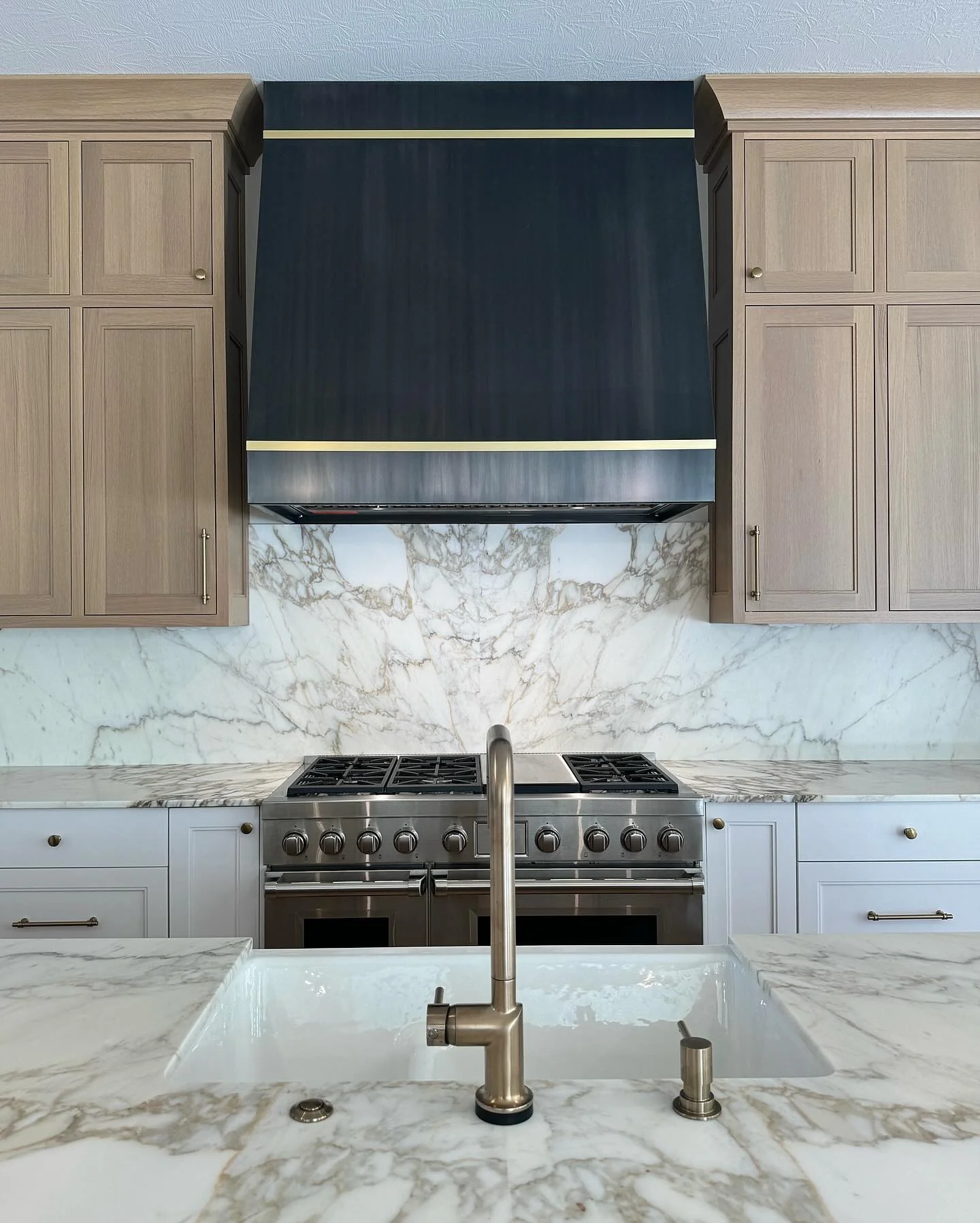 11. Calacatta-Inspired Luxury with Dual-Tone Cabinetry (Granite Countertops Kitchen Ideas)