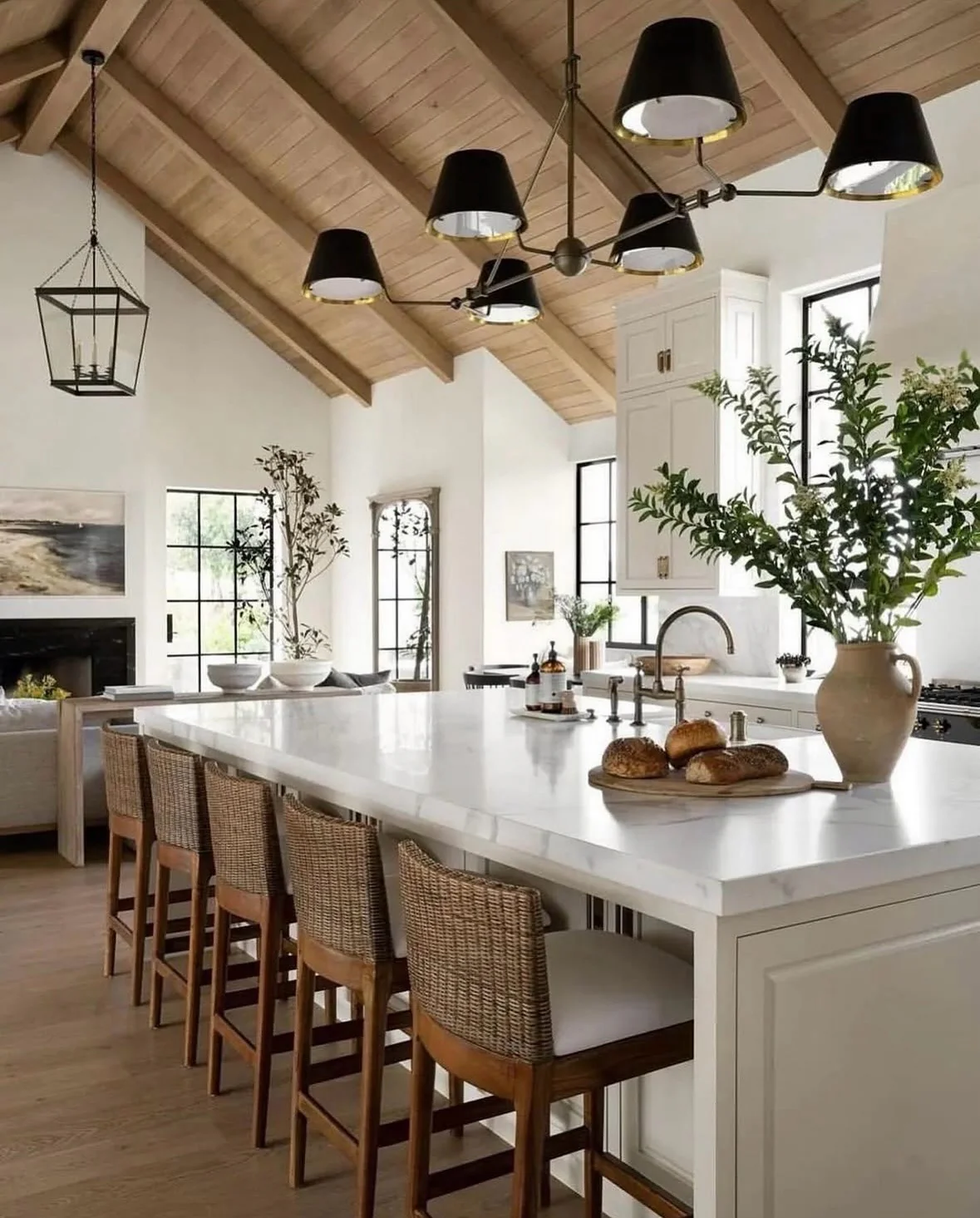 24. Open-Concept Elegance with Woven Seating (Farmhouse Kitchen Ideas)