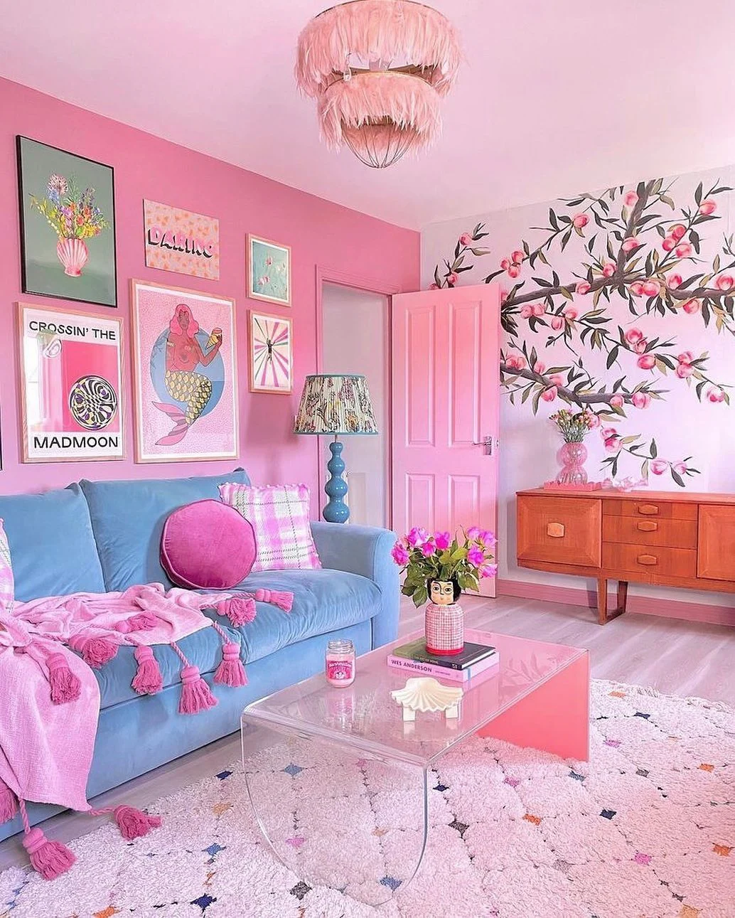 6. Eclectic Glamour with Retro Wall Art and Bold Color (Pink Living Room Ideas)