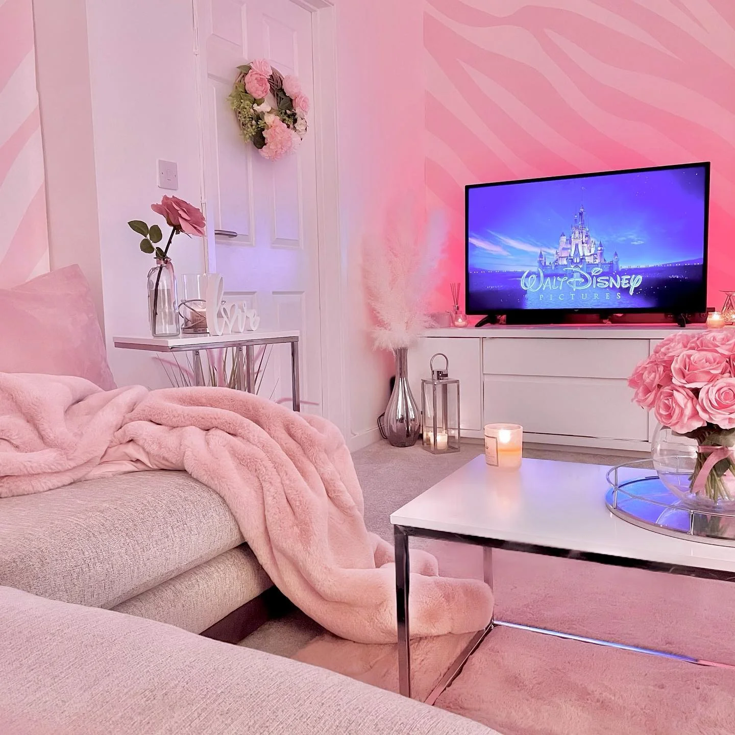 5. Soft Pink Glow with Cozy Movie Night Vibes (Pink Living Room Ideas)