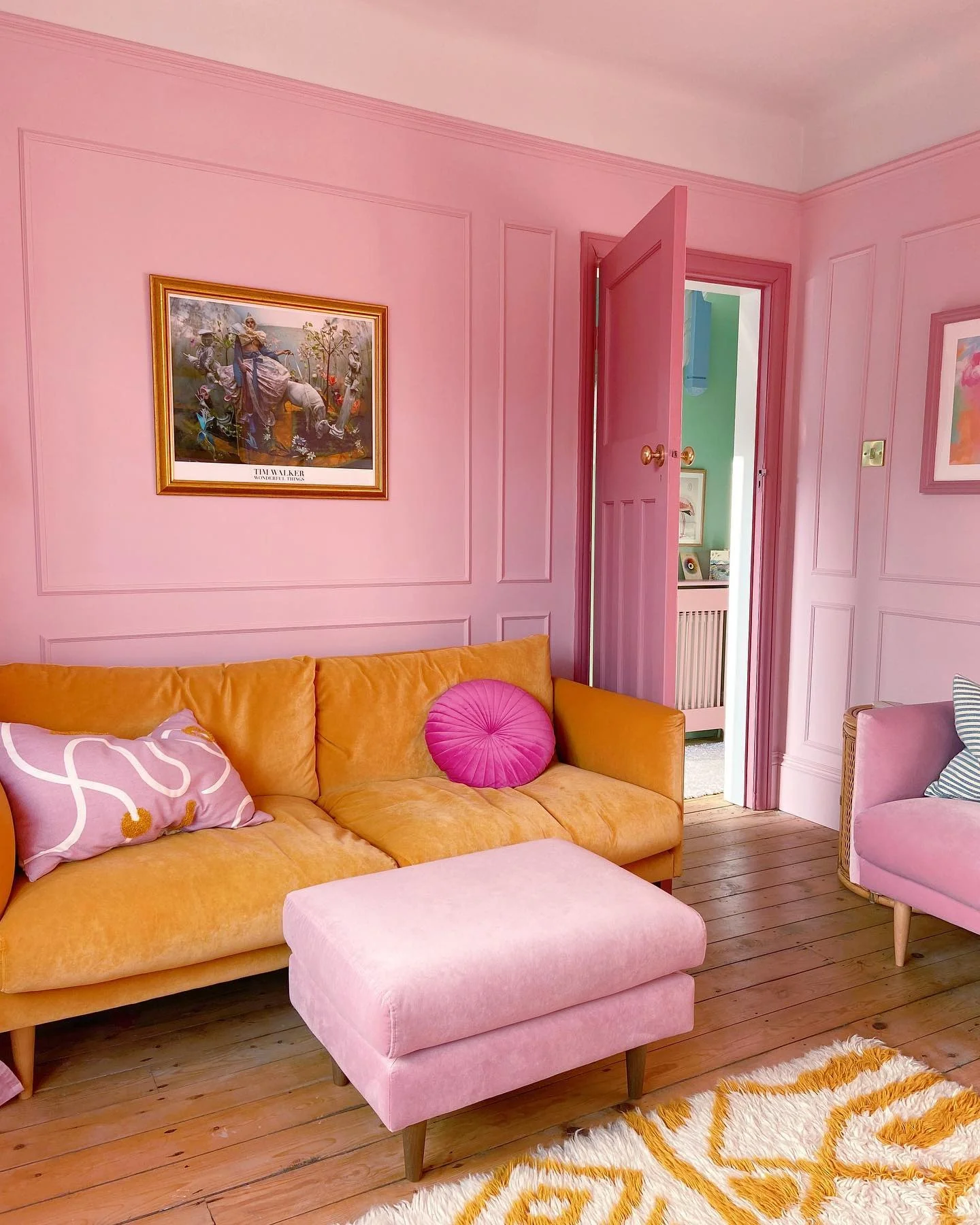 13. Vibrant Paneling with Citrus Accents (Pink Living Room Ideas)