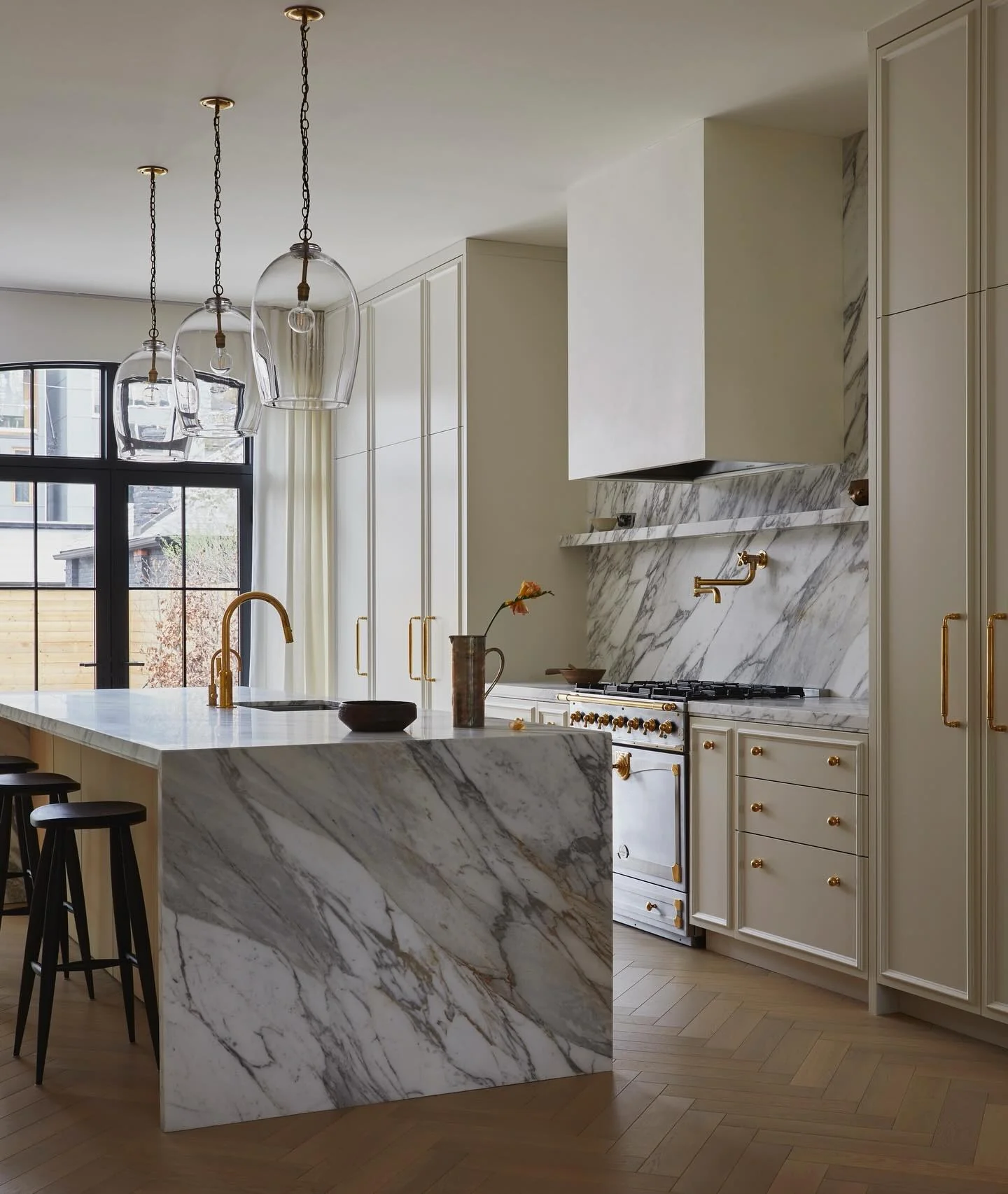 17. Bold Stonework with Brass Accents and Sculptural Lighting (classic kitchen ideas)