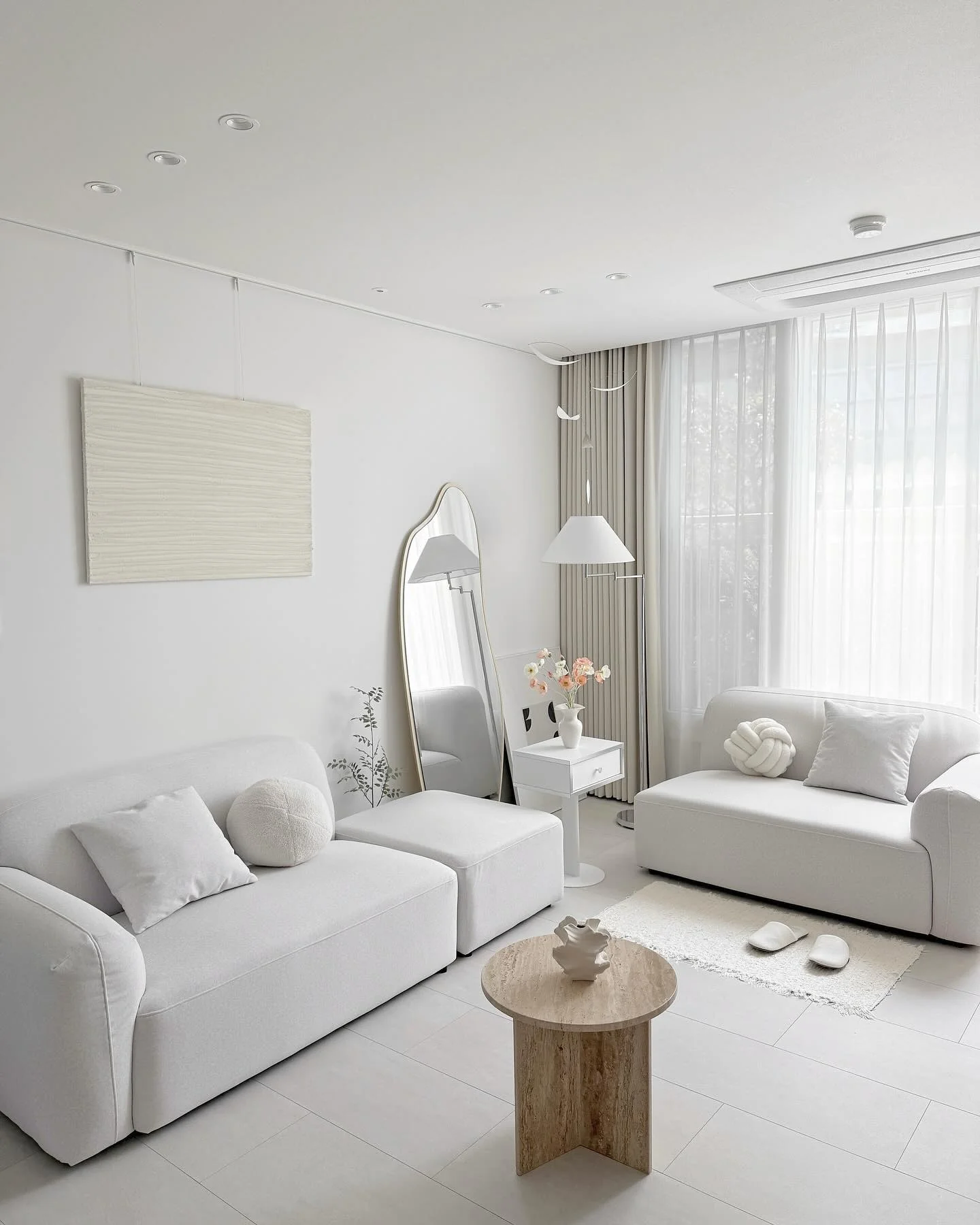 4. Subtle Curves in a Neutral Setting (White Living Room Ideas)
