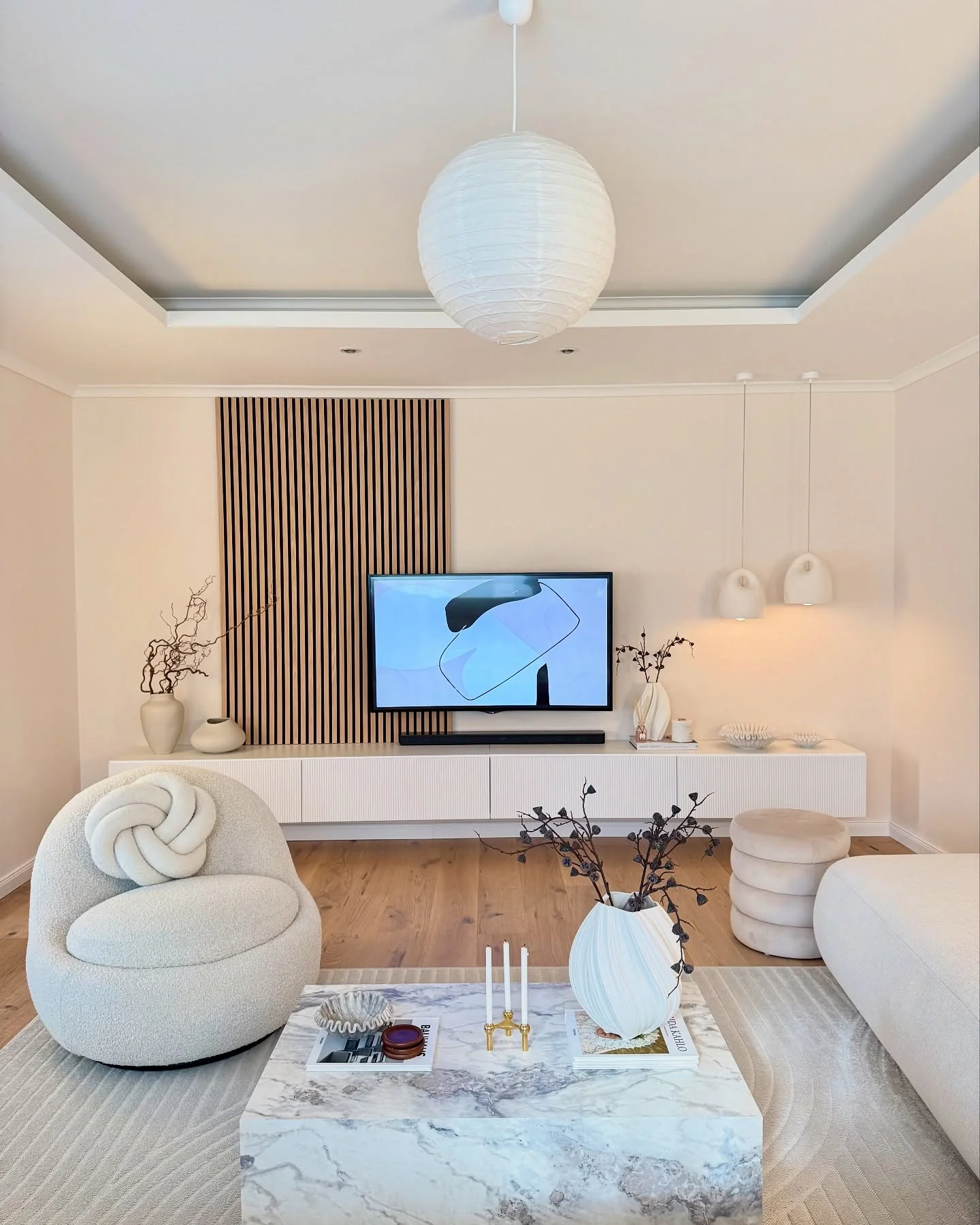 13. Sculpted Elegance in Warm White (White Living Room Ideas)