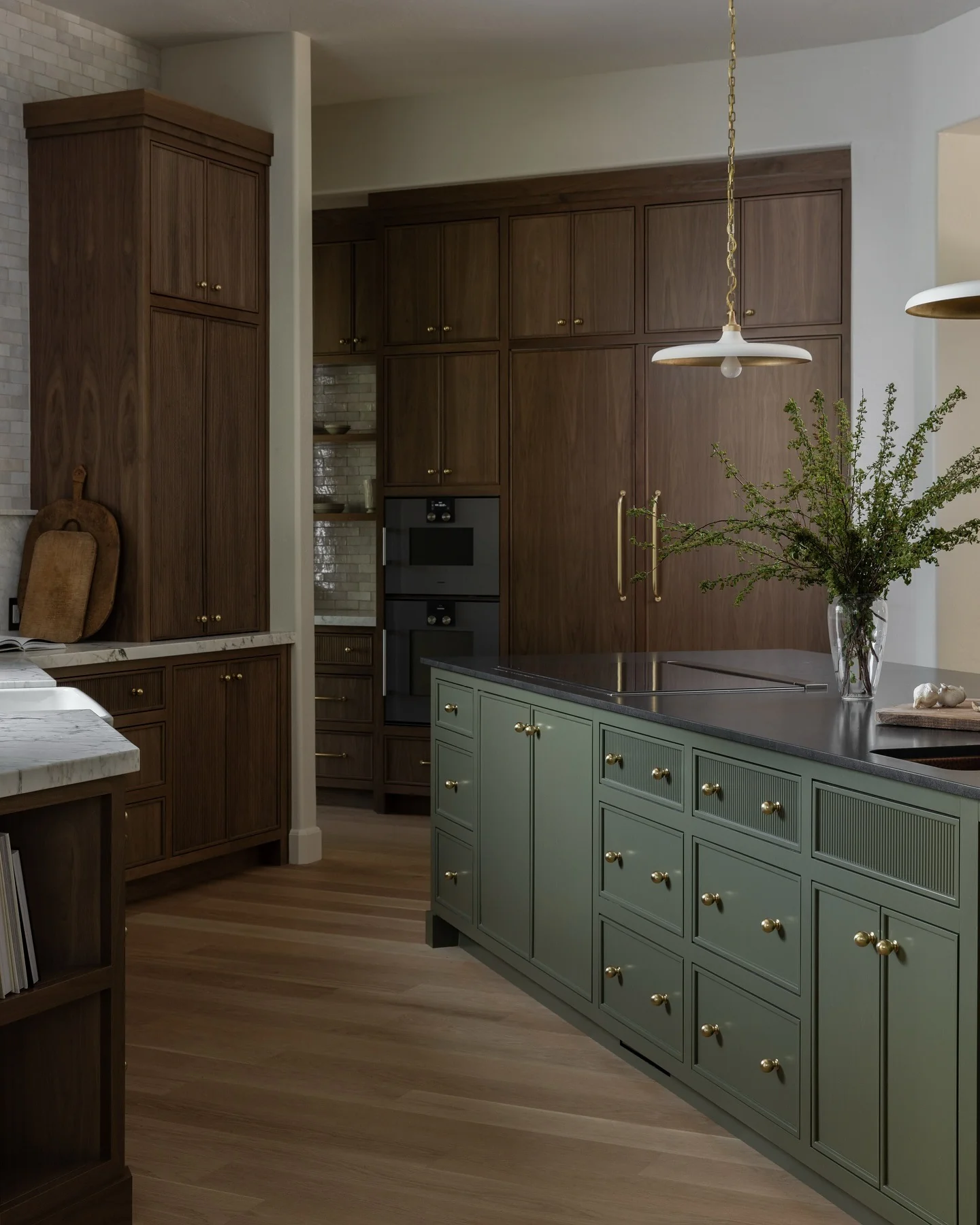 10. Sage Island with Rich Walnut Perimeter Cabinets (Dark Cabinets Kitchen Ideas)