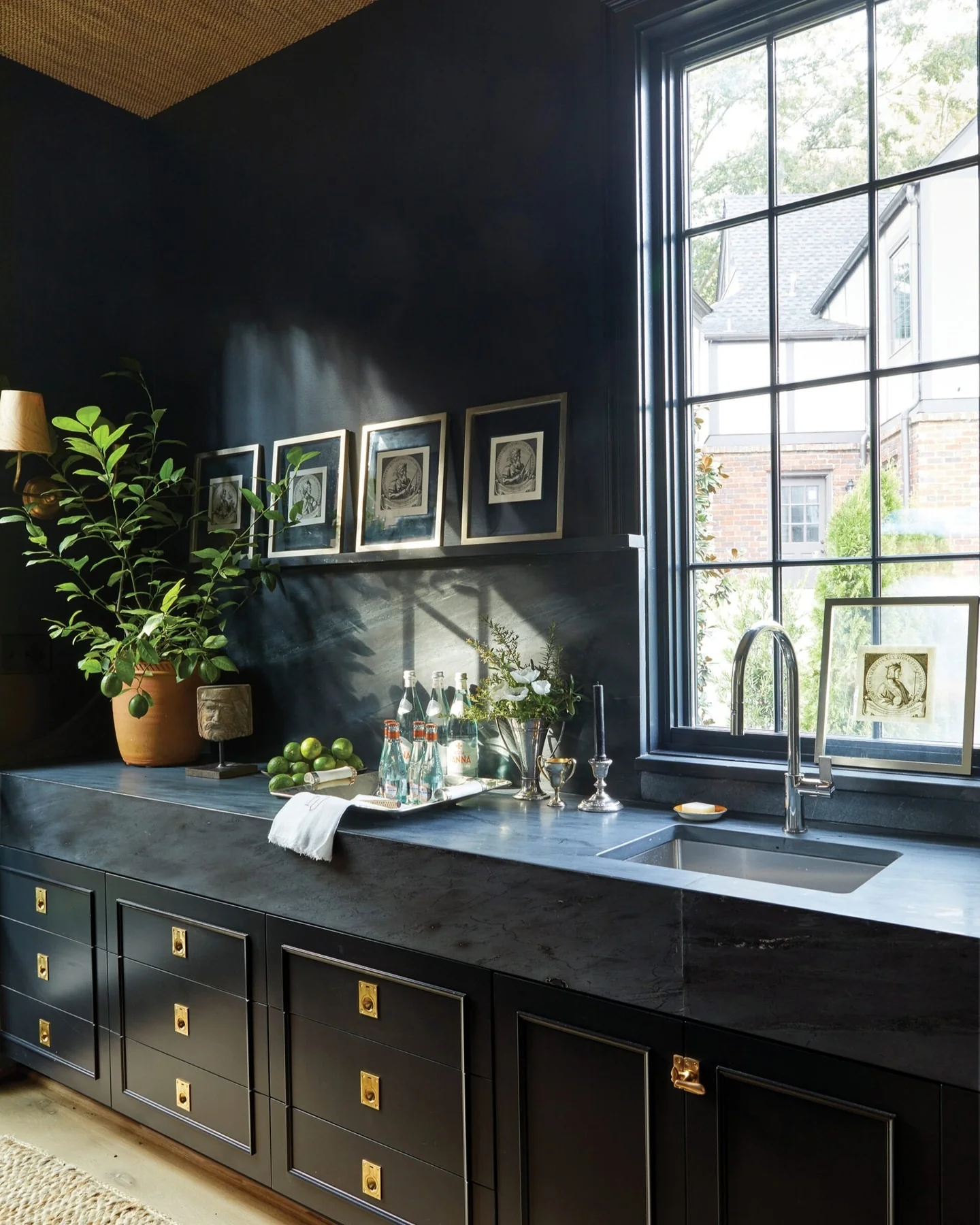 13. Ebony Flat-Panel Cabinets with Dramatic Stonework (Dark Cabinets Kitchen Ideas)