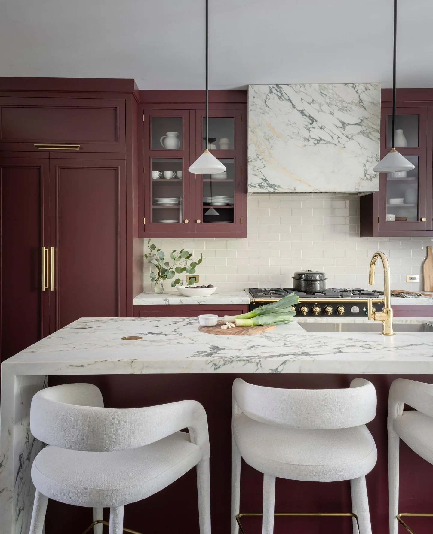 15. Deep Burgundy Cabinets with Waterfall Marble Island (Dark Cabinets Kitchen Ideas)