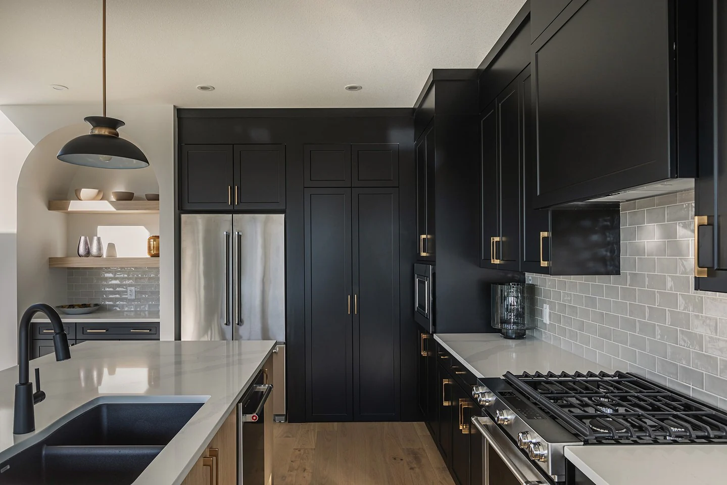 6. High-Contrast Function with Mixed Metals (Black Cabinets Kitchen Ideas)