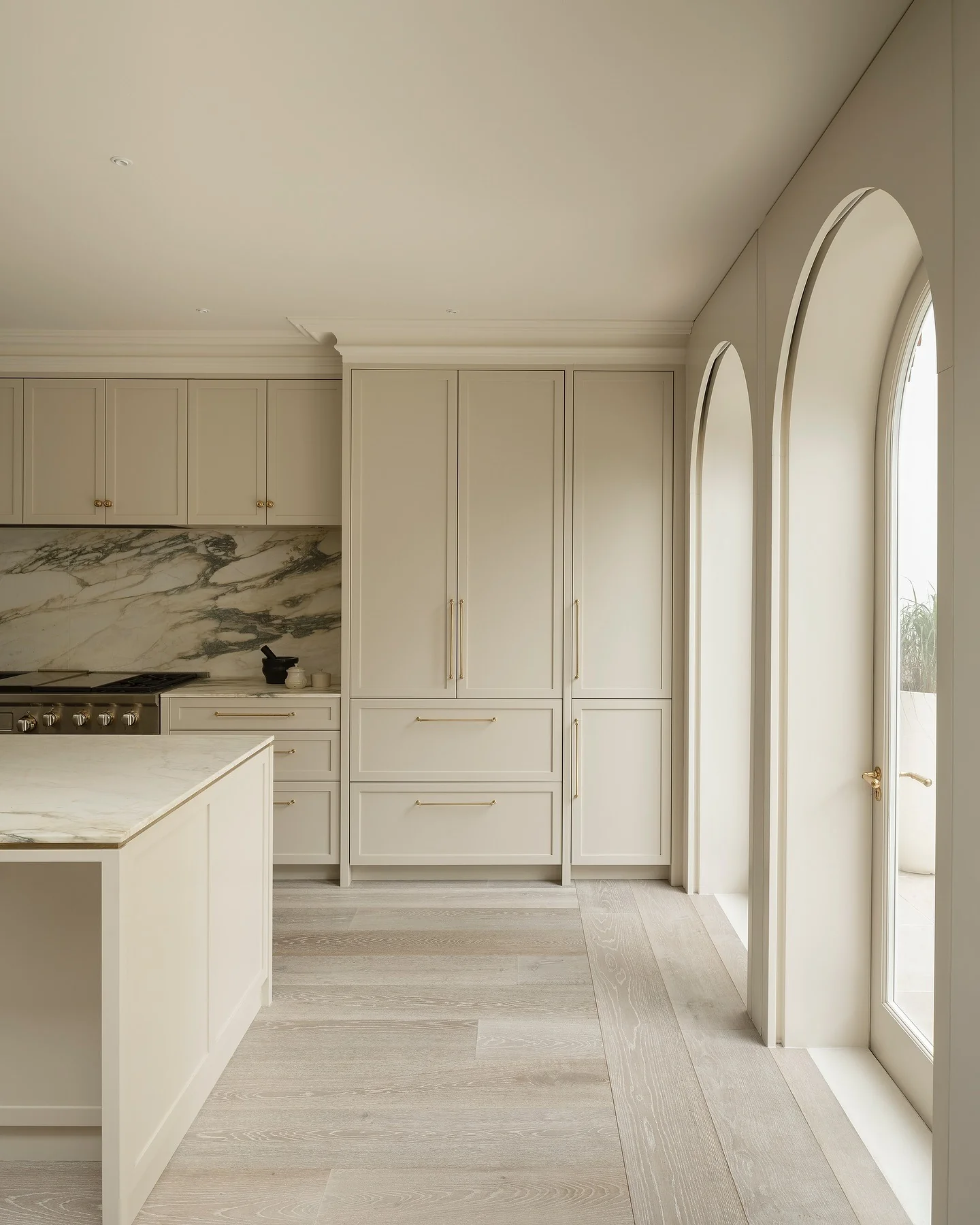 9. Mediterranean Breeze with Arched Elegance (Beige Kitchen Ideas)