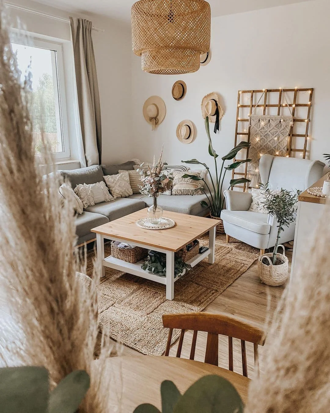 19. Hat Wall Boho with Organic Texture Layers (Boho Living Room Ideas)