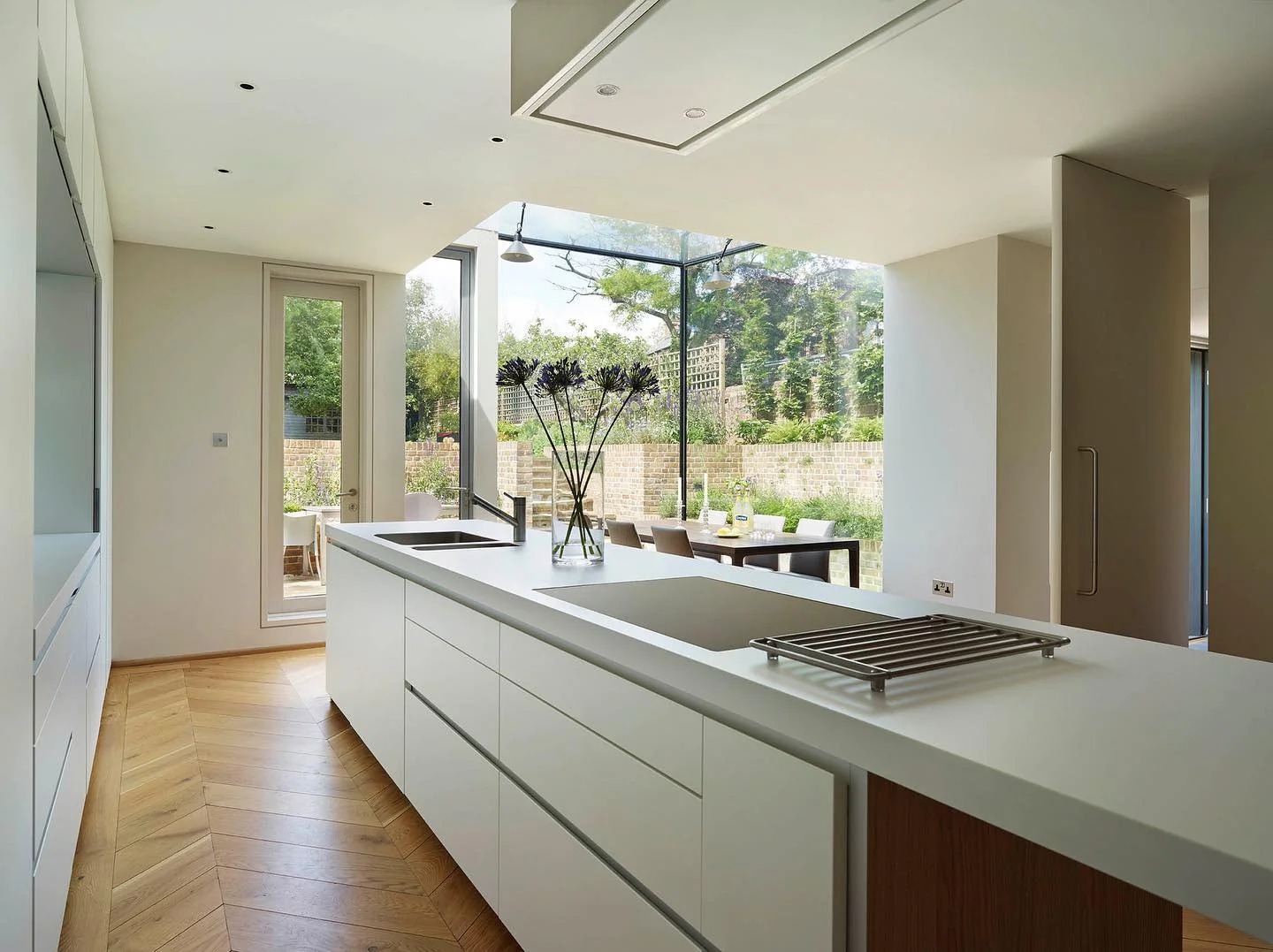 14. Minimalist White Kitchen with Floor-to-Ceiling Windows (Modern Kitchen Ideas)
