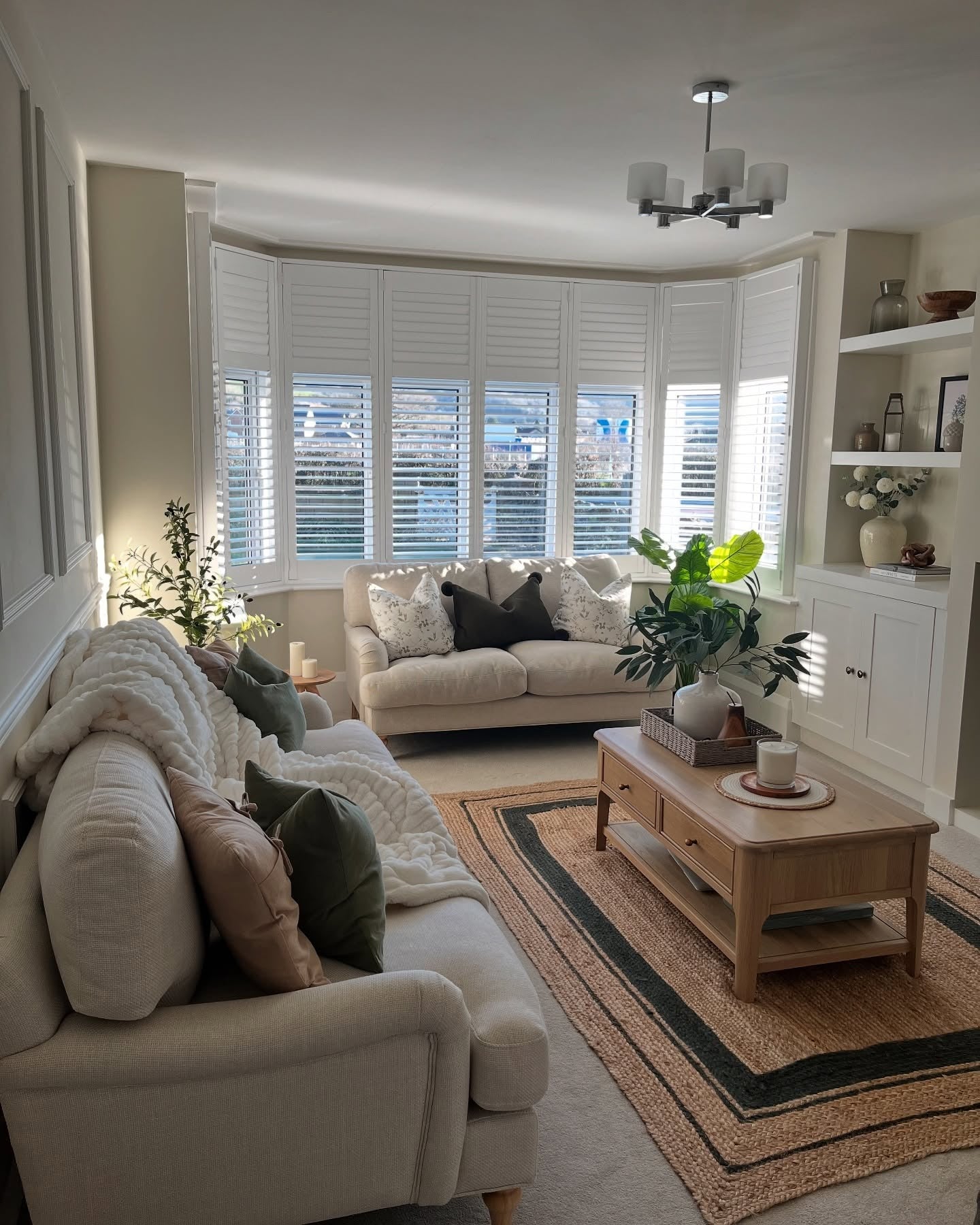 24. Neutral Elegance with Forest Accents (Earth Tones Living Room Ideas)