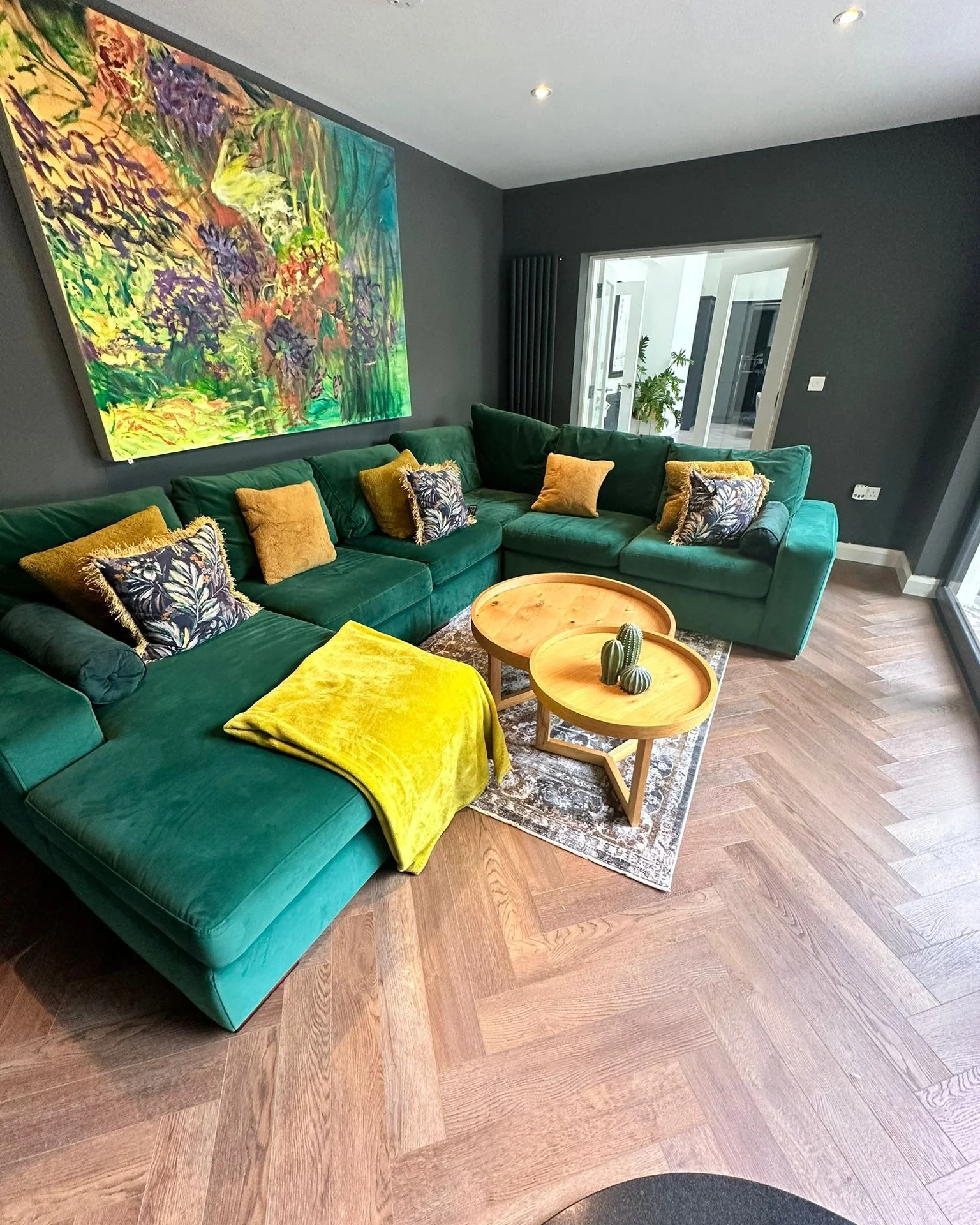 2. Moody Contemporary: Emerald Sectional with Mustard Gold Pops (Emerald Green and Gold Living Room Ideas)