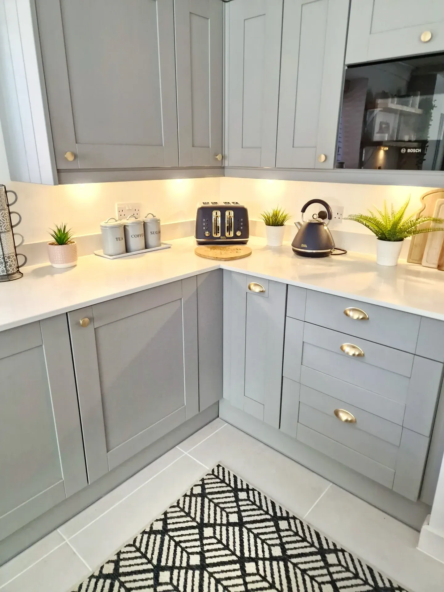 9. Soft Gray-White Contrast with Gold Accents (Small White Kitchen Ideas)