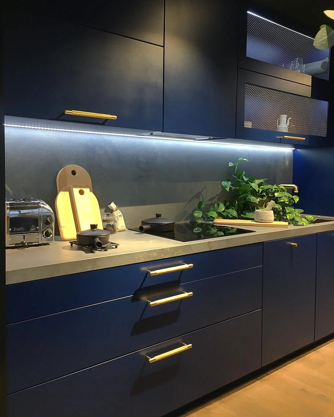 2. Modern Luxe with Matte Blue Cabinets (Dark Blue Kitchen Ideas)