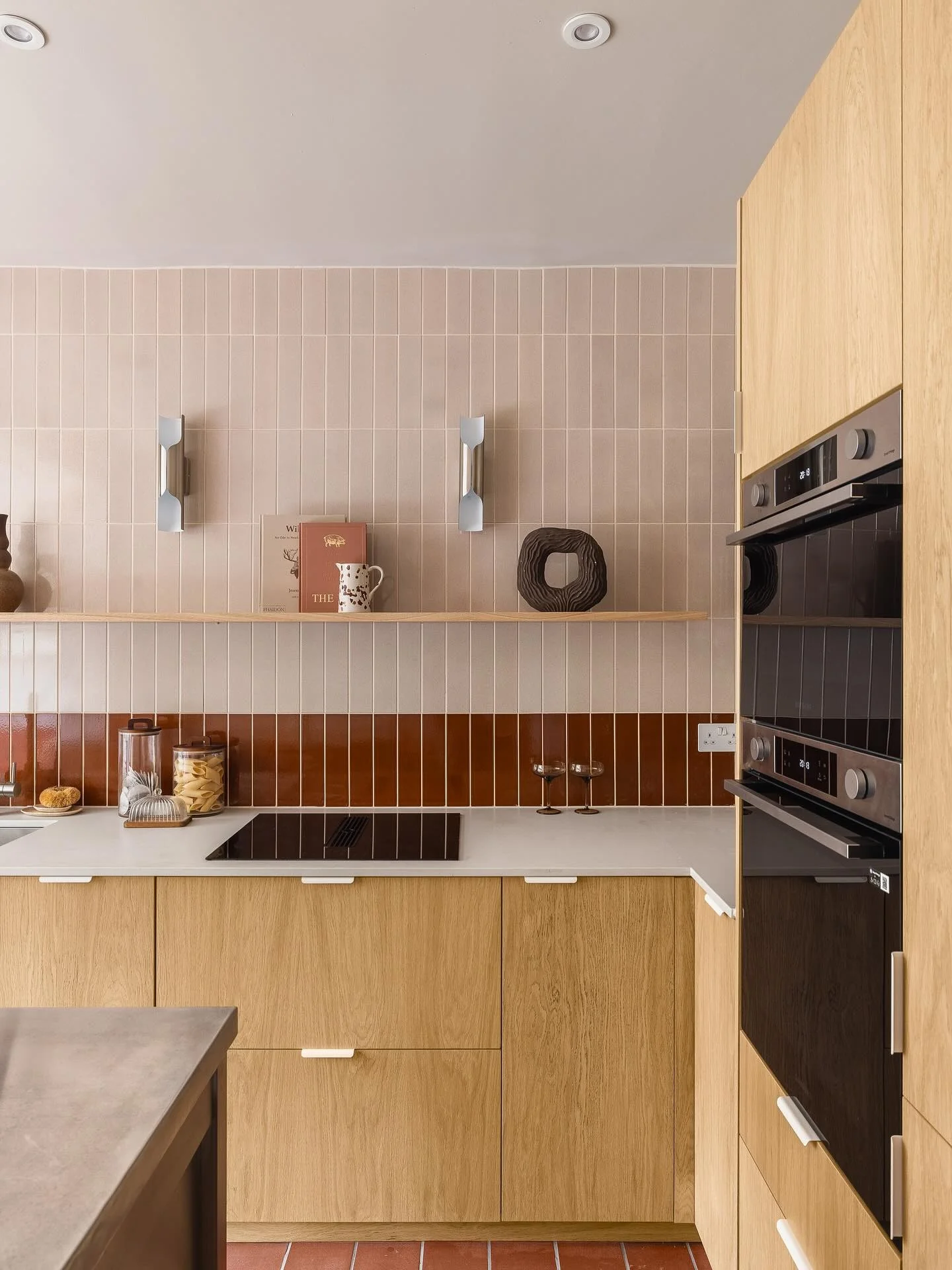 12. Modern Maple Kitchen with Blush Vertical Tile + Rust Accent Band + Matte Black Appliances (Maple Cabinet Kitchen Ideas)