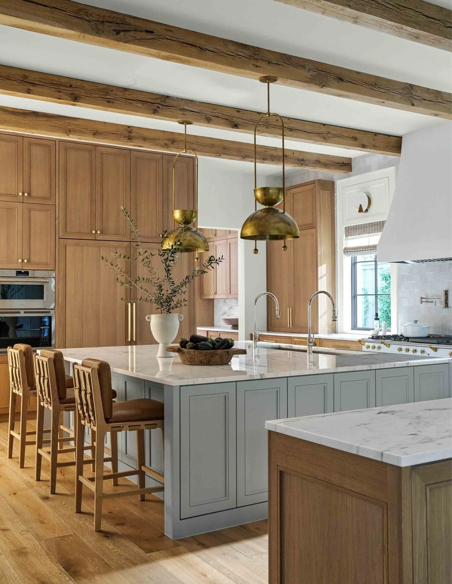 4. Airy Farmhouse Maple Kitchen with Brass Lighting + Exposed Wood Beams (Maple Cabinet Kitchen Ideas)
