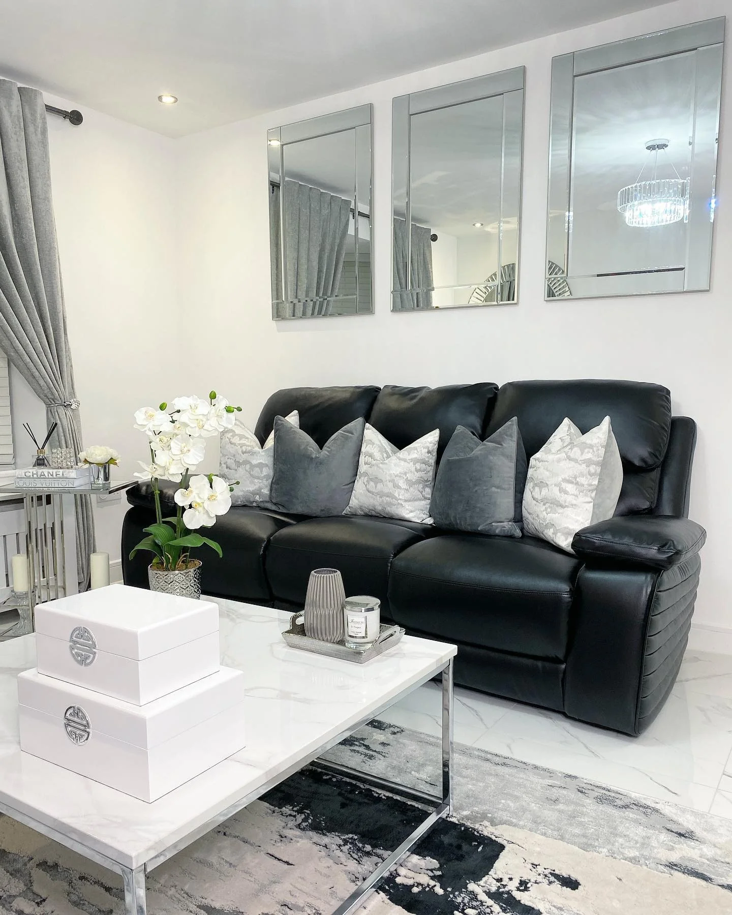 1. Monochrome Elegance with Metallic Accents (Black Furniture Living Room Ideas)