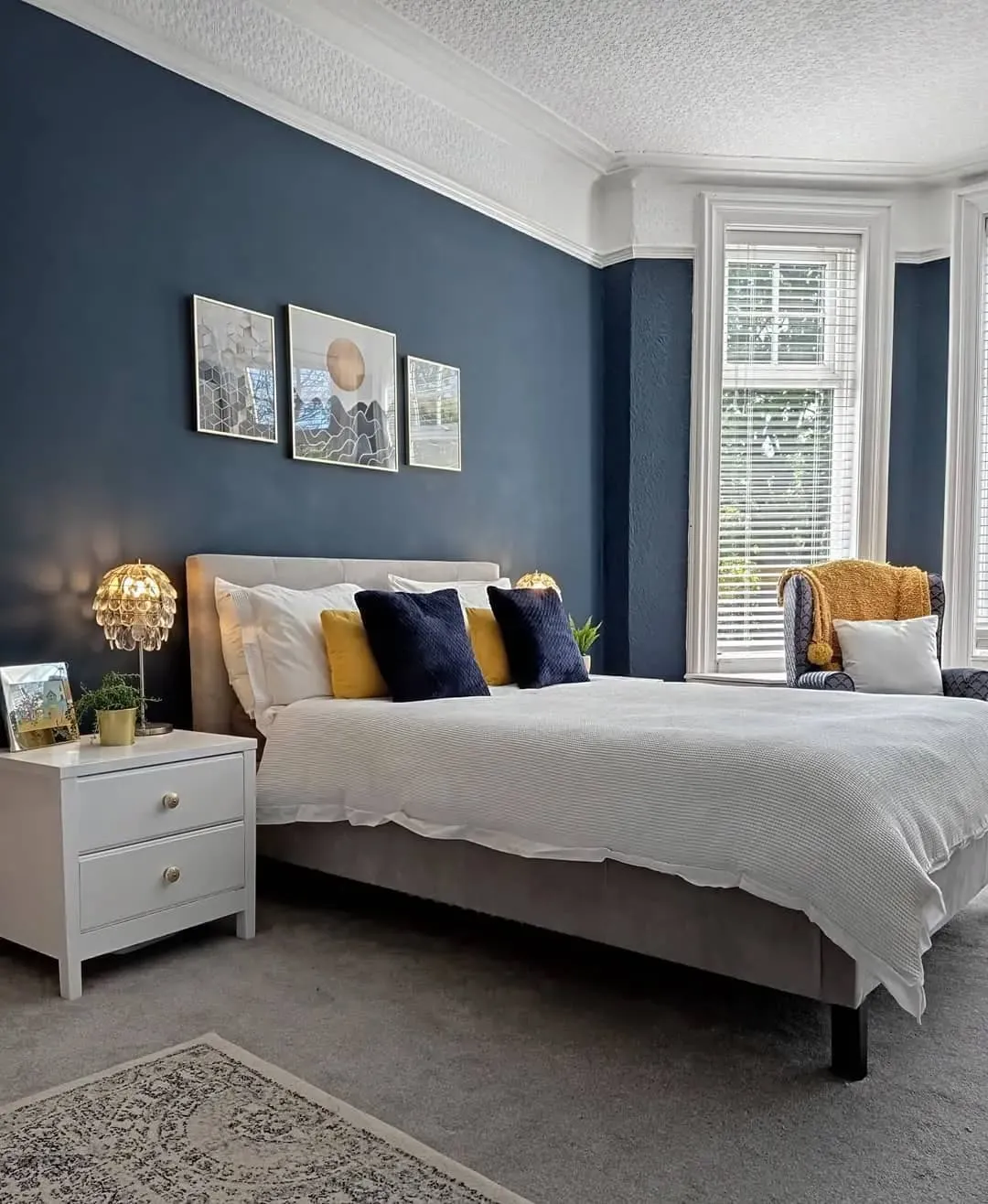 1. Navy and Mustard Contrast Bedroom (Blue Wall Bedroom Ideas)
