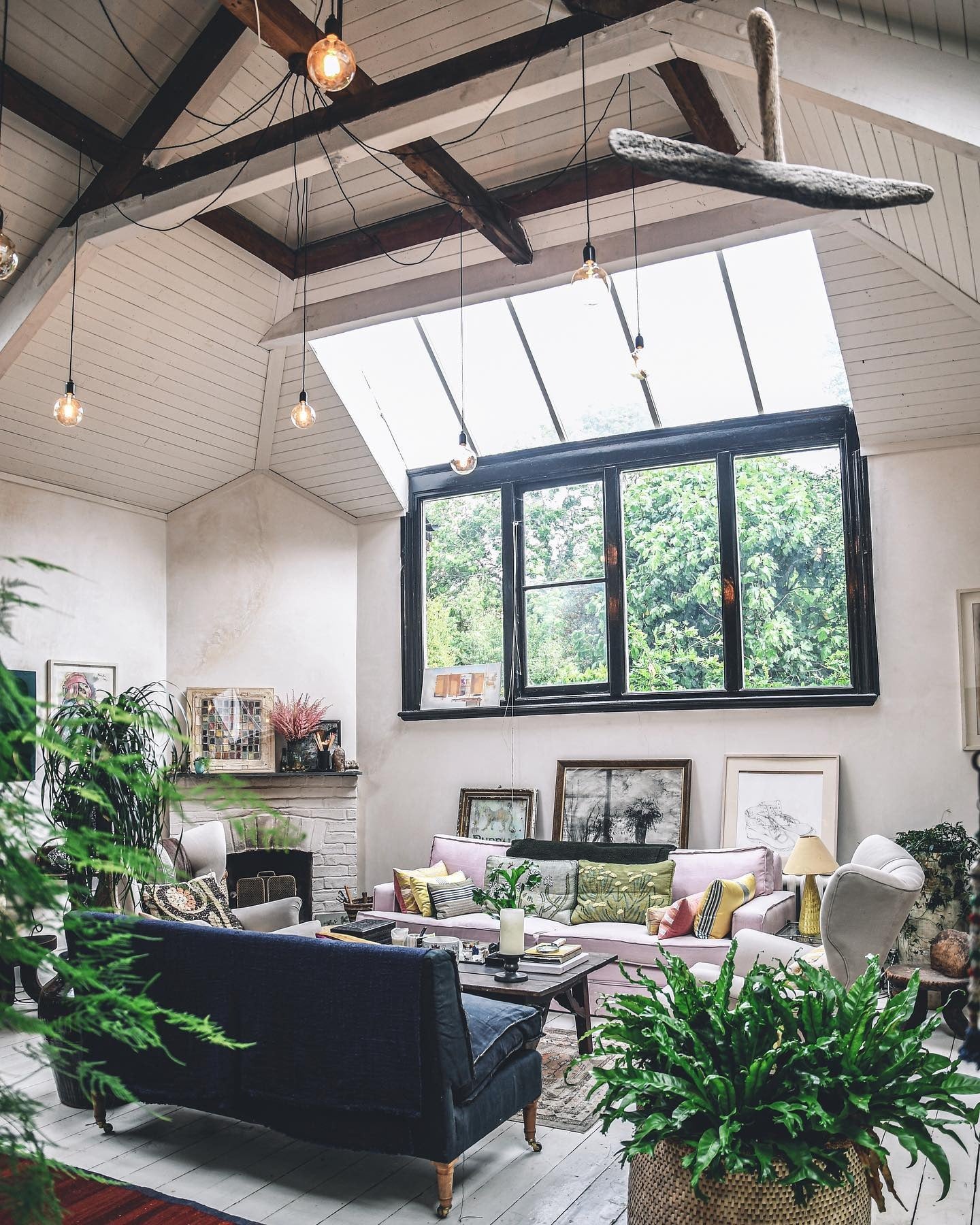 9. Loft-Style Jungle Living Room with Industrial Details and Blush Accents (Jungle Living Room Ideas)