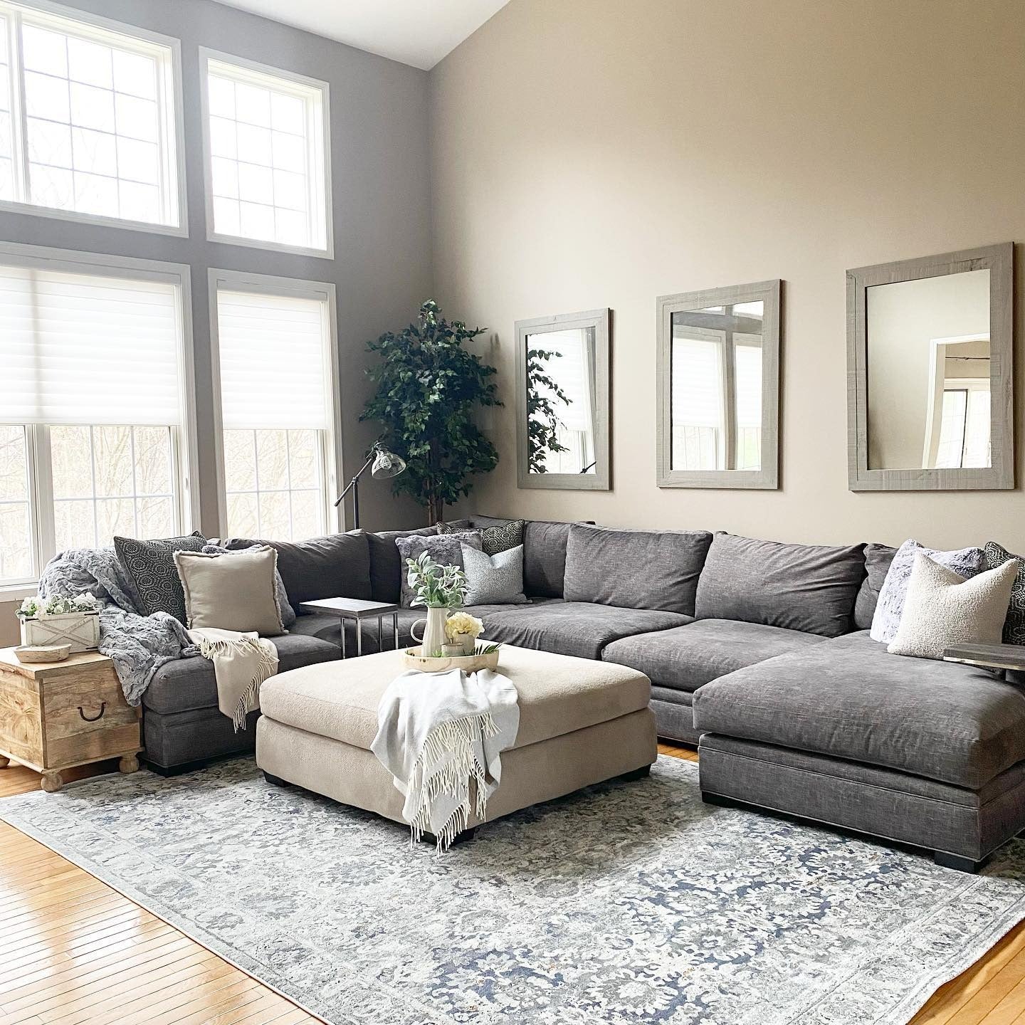 1. Soft Gray Sectional with Layered Neutrals (Living Room Rug Ideas)