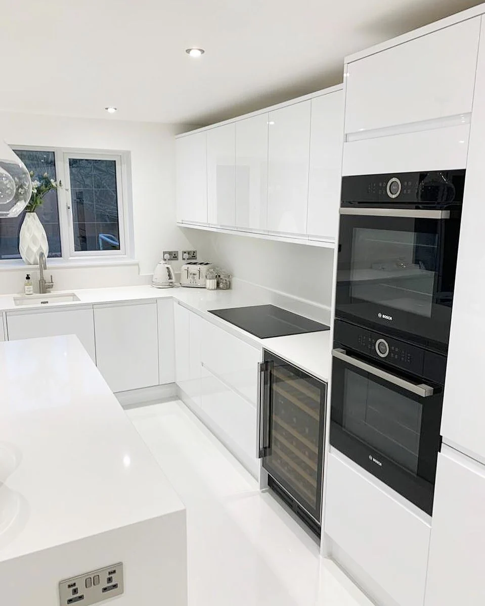 1. Sleek White Minimalism with Glossy Finishes (White Kitchen Floor Ideas)