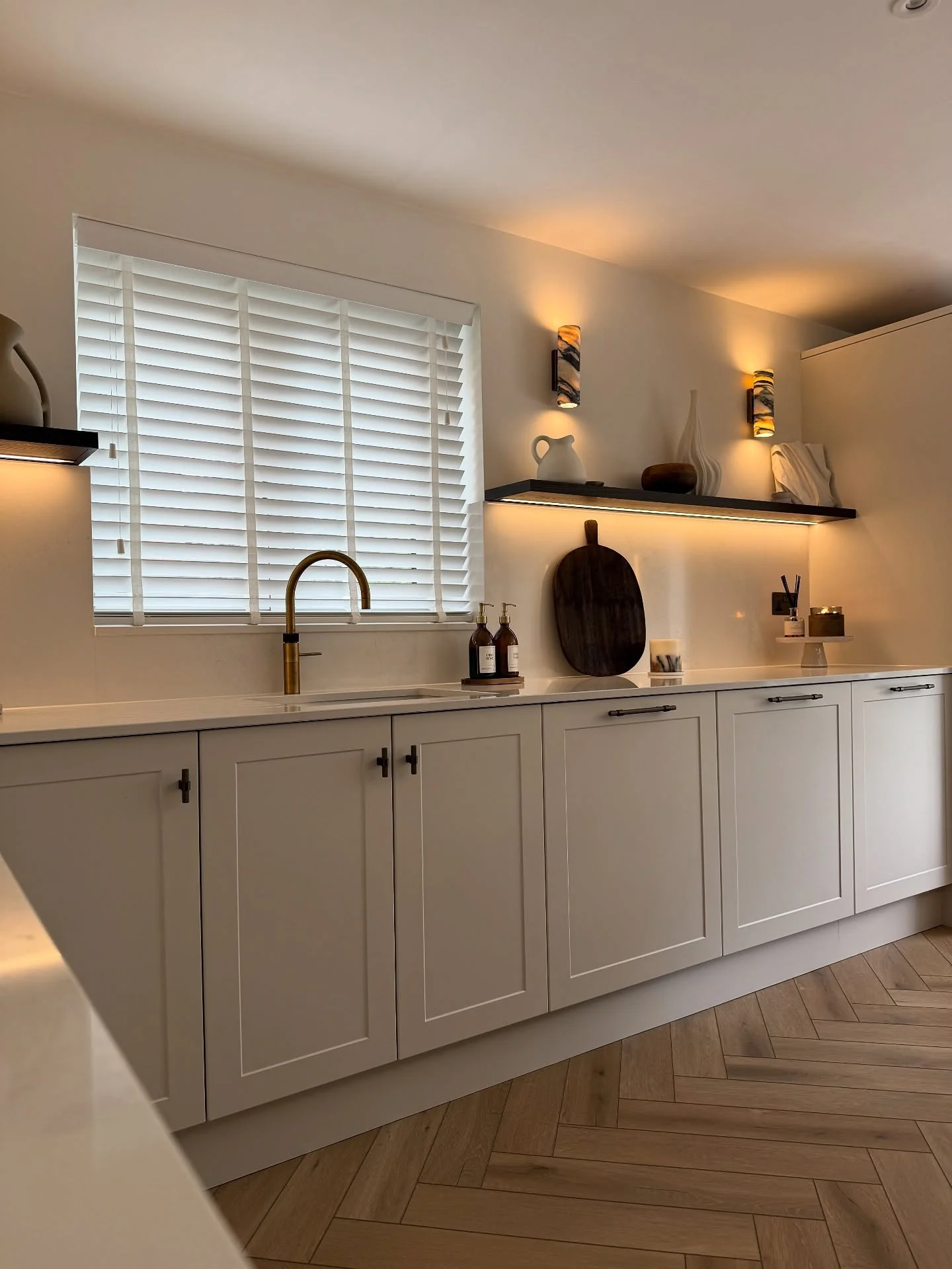 1. Warm White Shaker Kitchen with Layered Lighting (Long Narrow Kitchen Ideas)