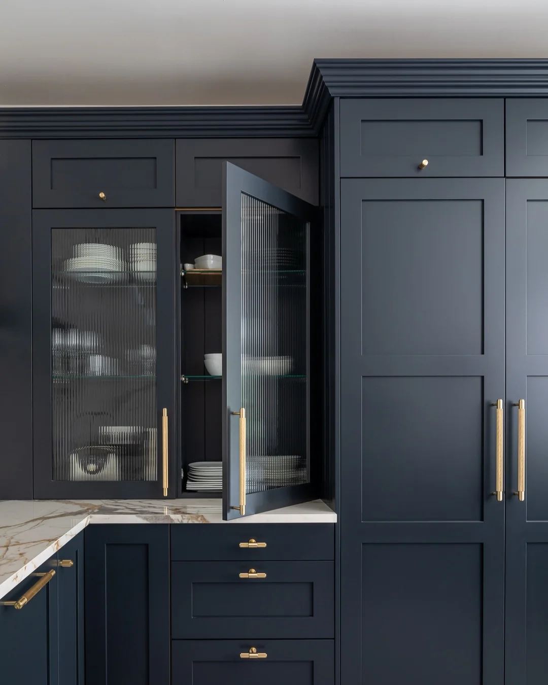 15. Classic Navy Pantry Wall With Reeded Glass Doors and Satin Brass Hardware (Navy Blue Kitchen Cabinets Ideas)