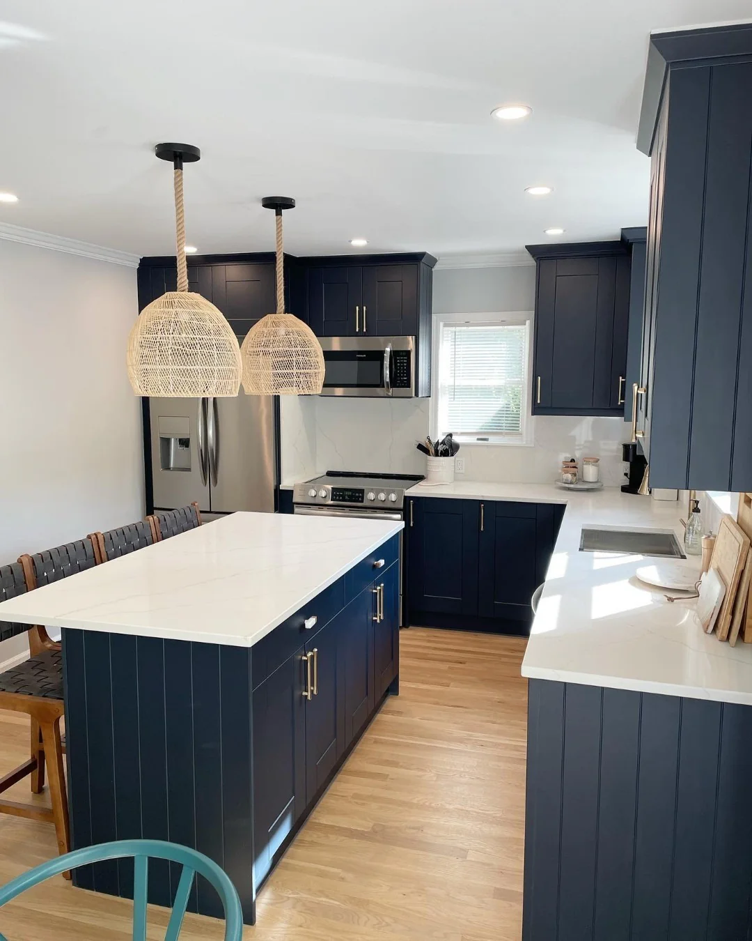12. Coastal-Inspired Navy Kitchen With Rope Pendants, White Quartz & Warm Brass Hardware (Navy Blue Kitchen Cabinets Ideas)