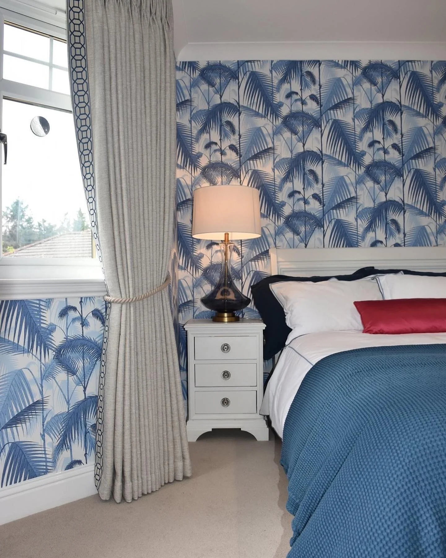 1. Tropical Elegance with Navy Accents (Blue and White Bedroom Ideas)