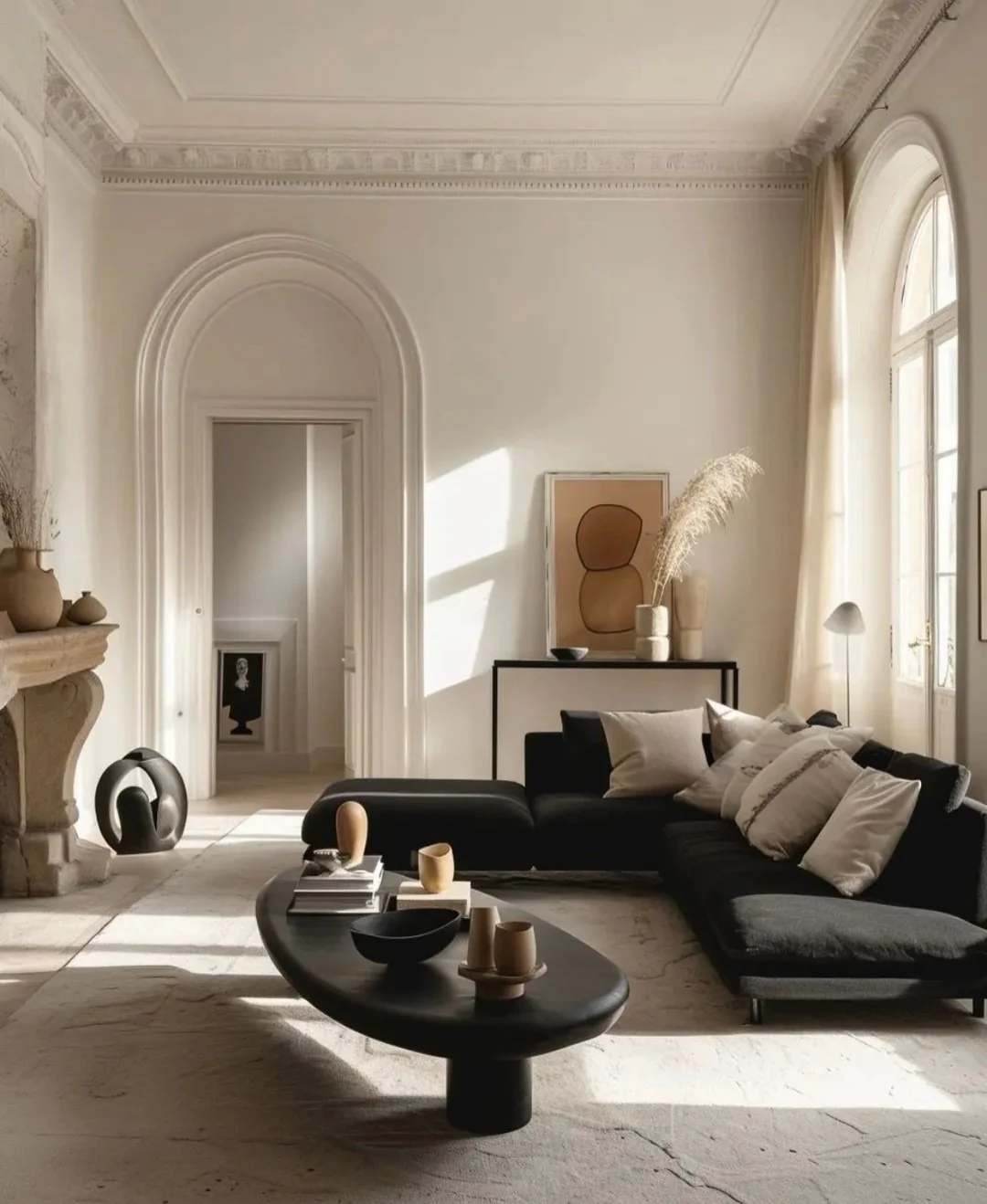 12. Black Sectional with Cream Layers in a Parisian-Inspired Neutral Living Room (Dark Sofa Living Room Ideas)